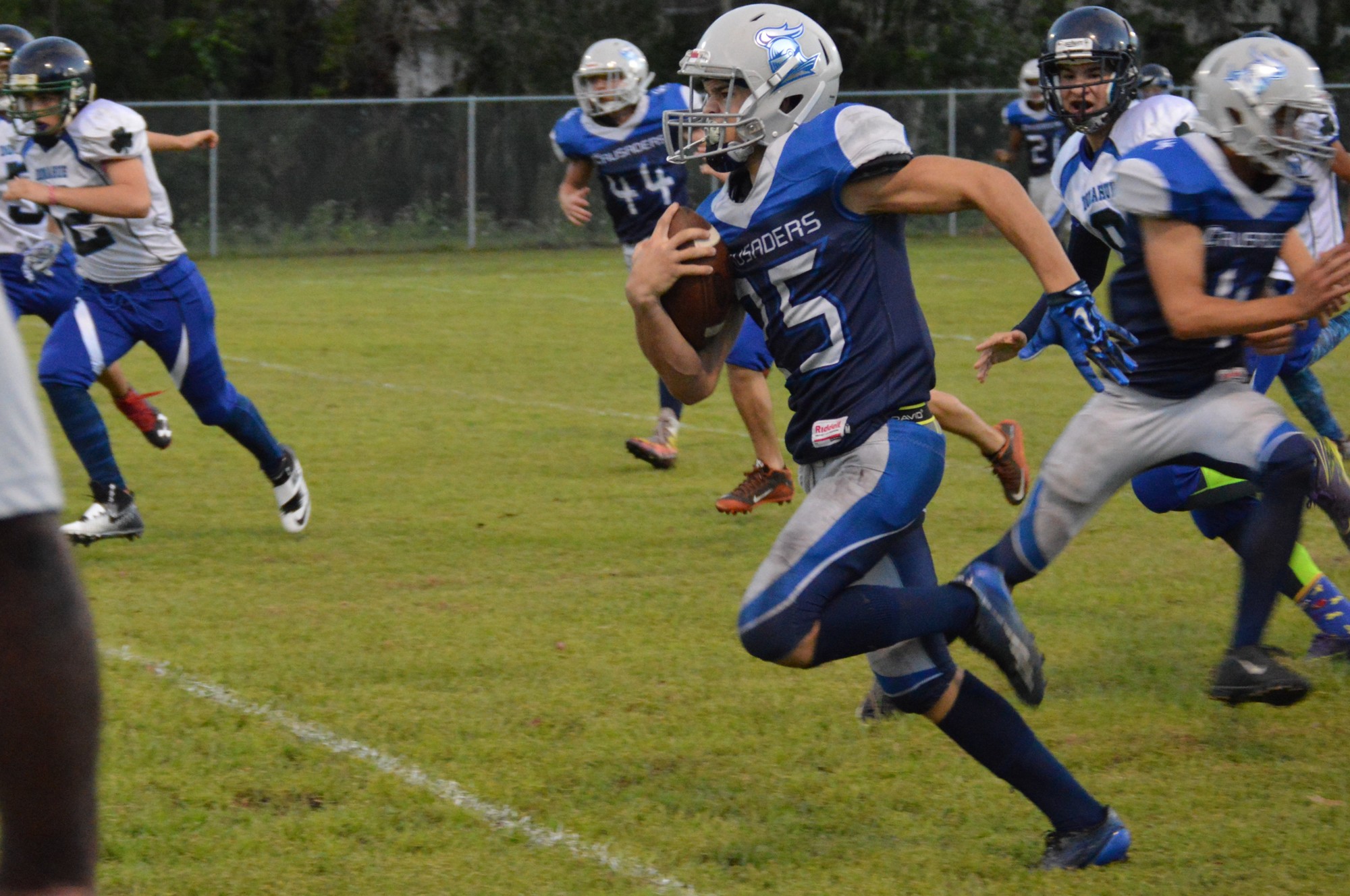 The Crusaders' Zayne Smith runs with the ball during FBCA's game against Donahue Catholic. Zayne returned a punt 60 yards for a touchdown. Photo courtesy of Stephanie Sumler