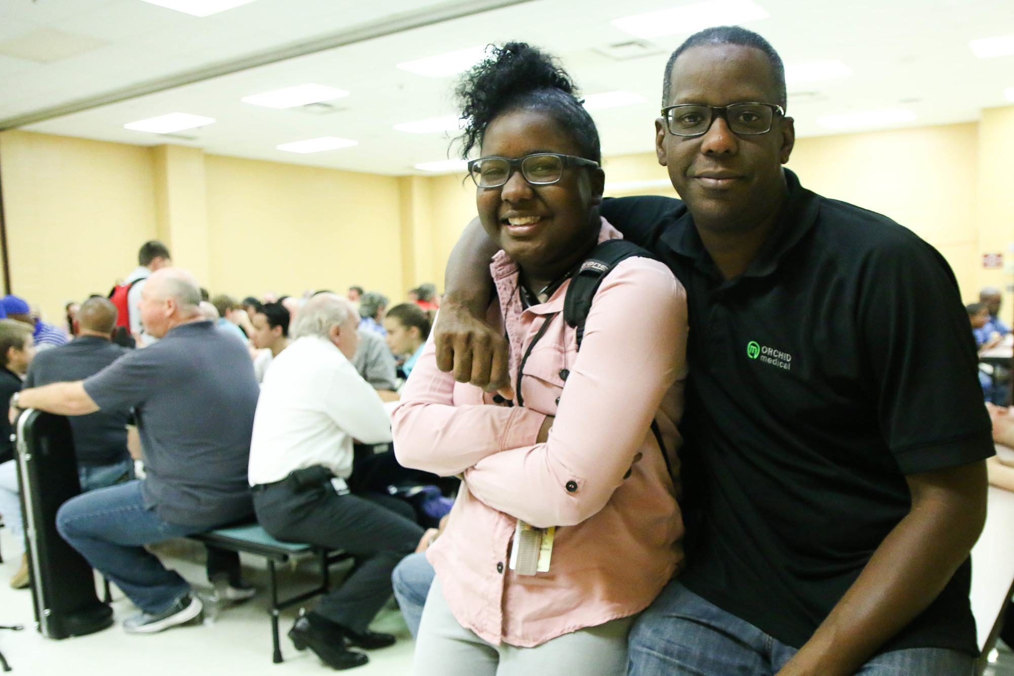 Chloe Walker sits with her father, Deshawn Walker. Photo by Paige Wilson
