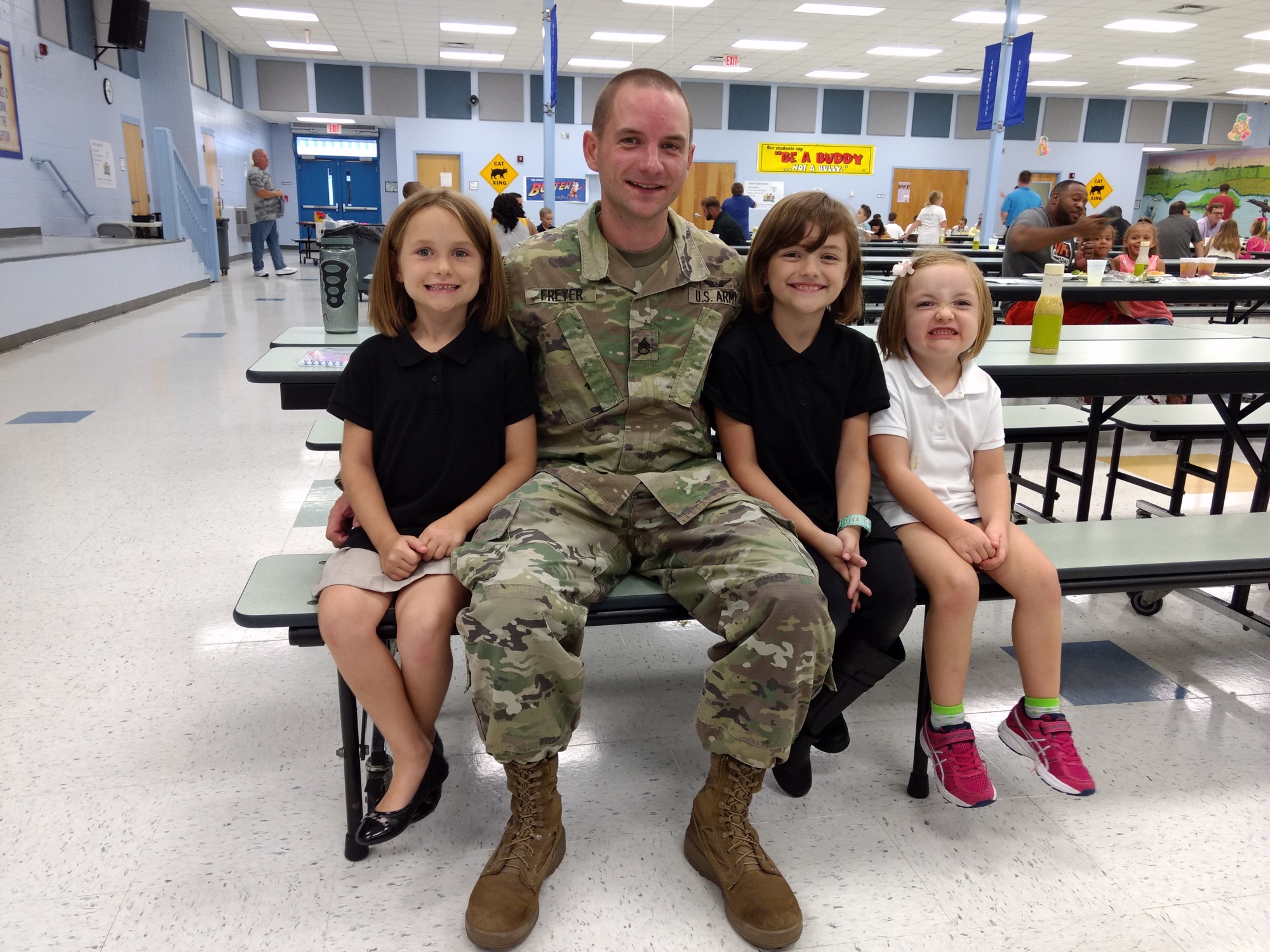 Staff Sgt. Robert Freyer with his daughters, Kylie, Lailonie and Hailey. Photo by Brian McMillan