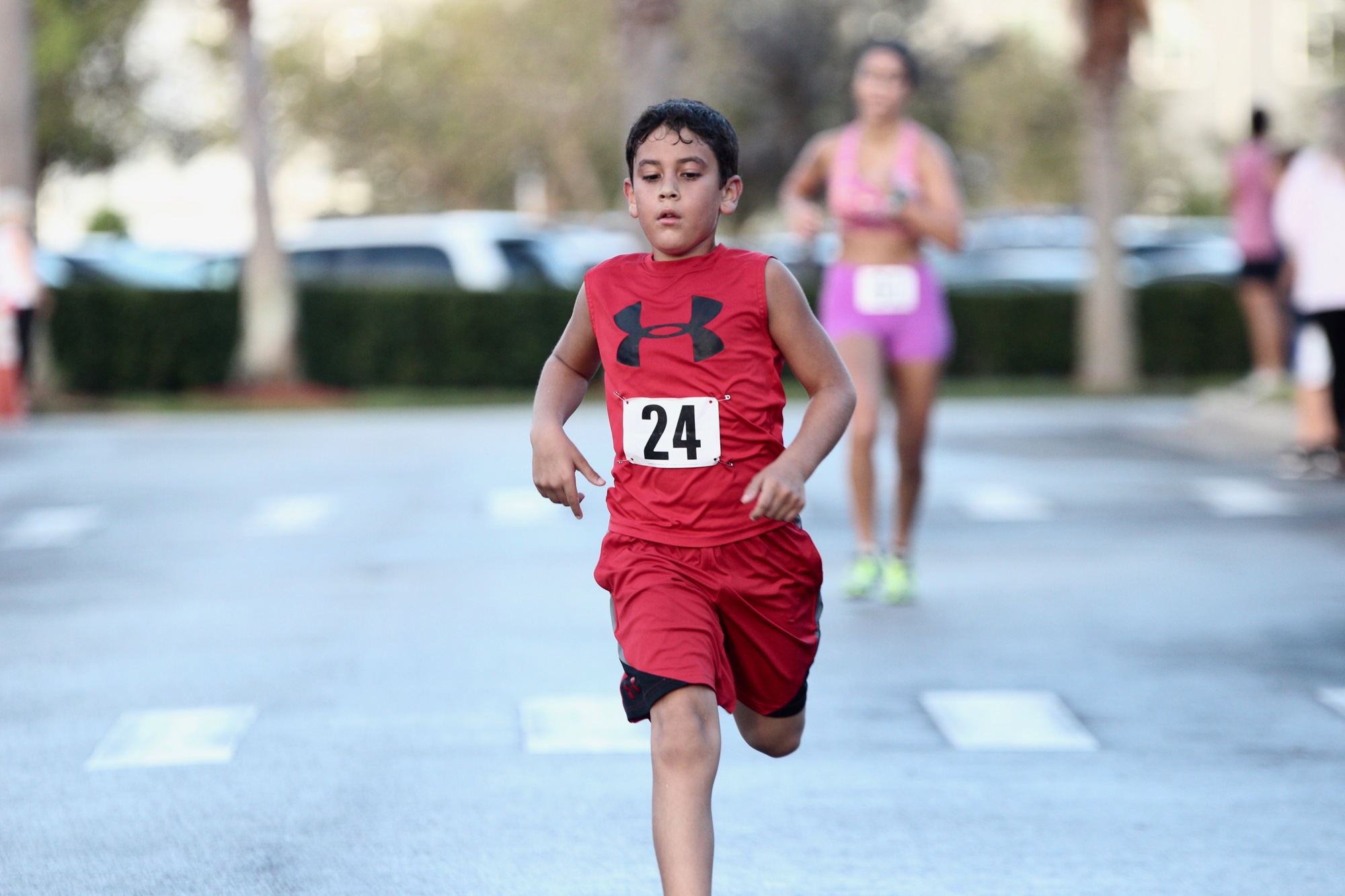 Ten-year-old C. Baeza dashes toward the finish line at FHF's Pink 5K run. Photo by Ray Boone
