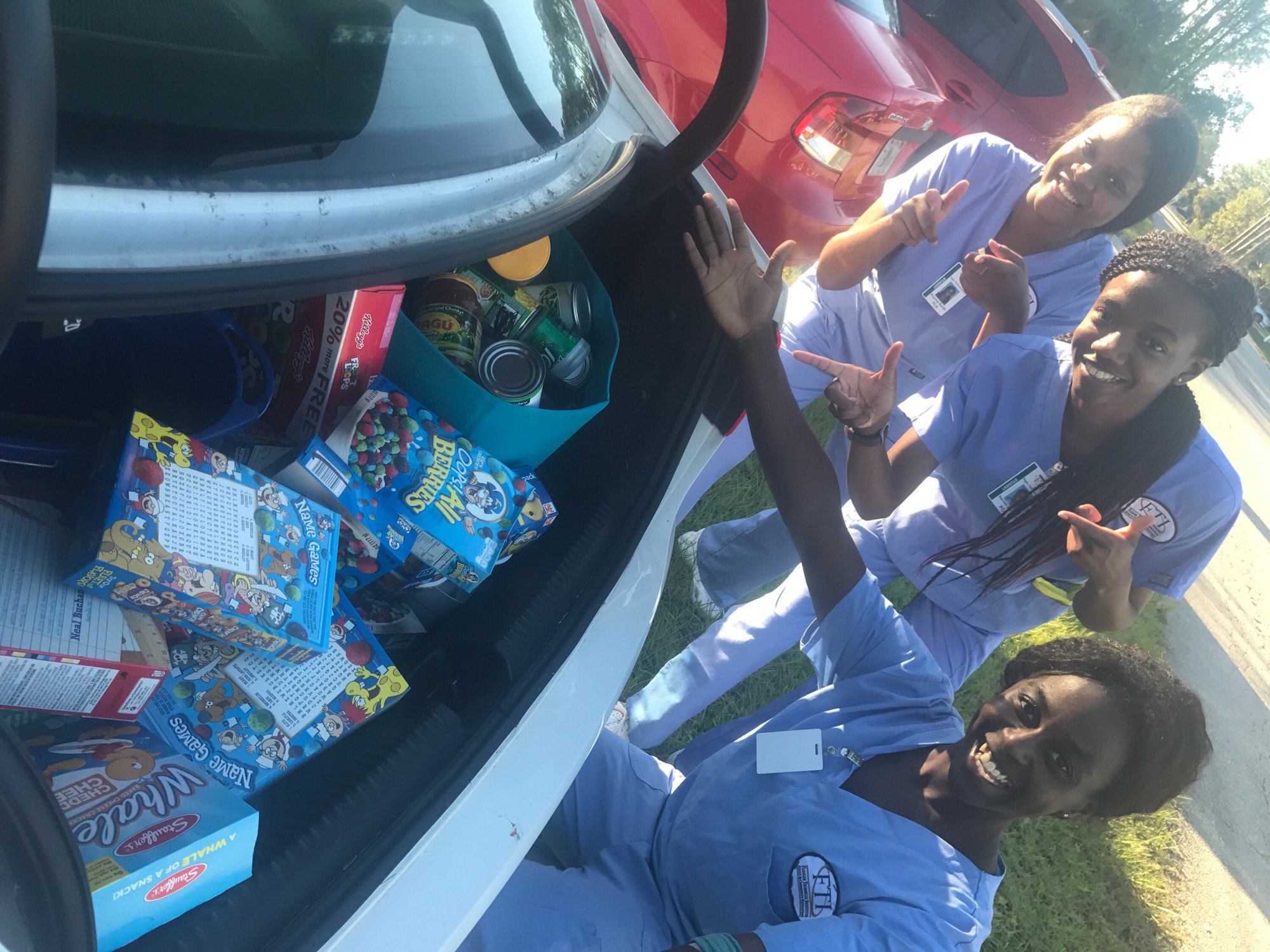 Flagler Technical Institute Patient Care Assistant students Dereatha Sanders, Namiah Simpson and Kiyona Smith make a delivery to the Salvation Army food bank. Photo courtesy of Kathryn Weed