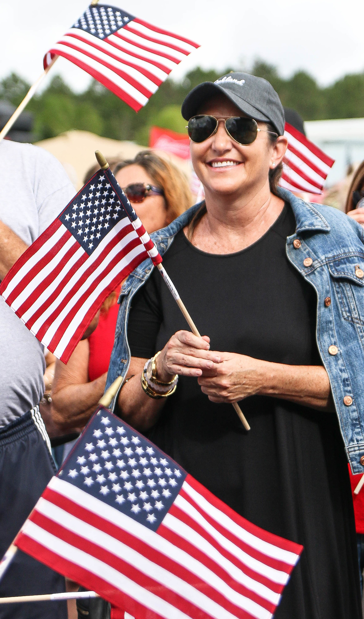Palm Coast Mayor Milissa Holland holds an American flag in the crowd. Photo by Paige Wilson