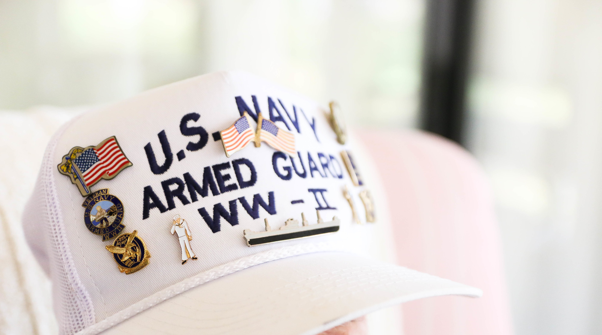 Frank Hedrick's hat is decorated with military honors. Photo by Paige Wilson