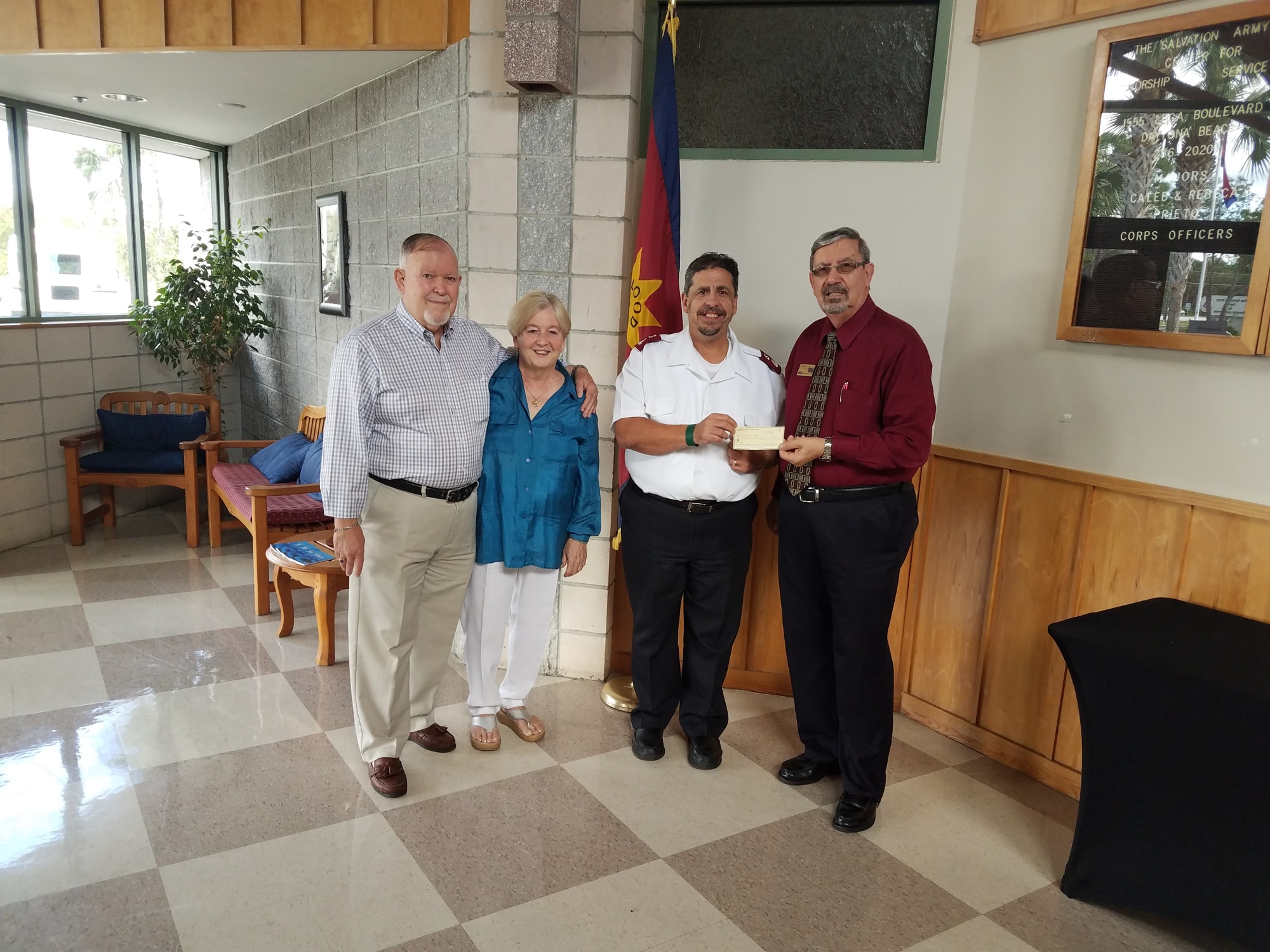 Jim and Melanie Bolling and Carmen Bongiovanni, president of the Columbian Club of Flagler County, present the donation check to Major Caleb Prieto of the Salvation Army. Photo courtesy of Carmen Bongiovanni 