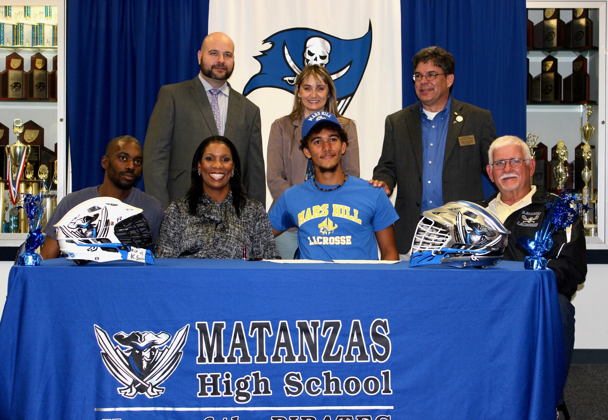 Jackson Courson smiles after signing his letter of intent to play lacrosse for Mars Hill. Photo by Ray Boone