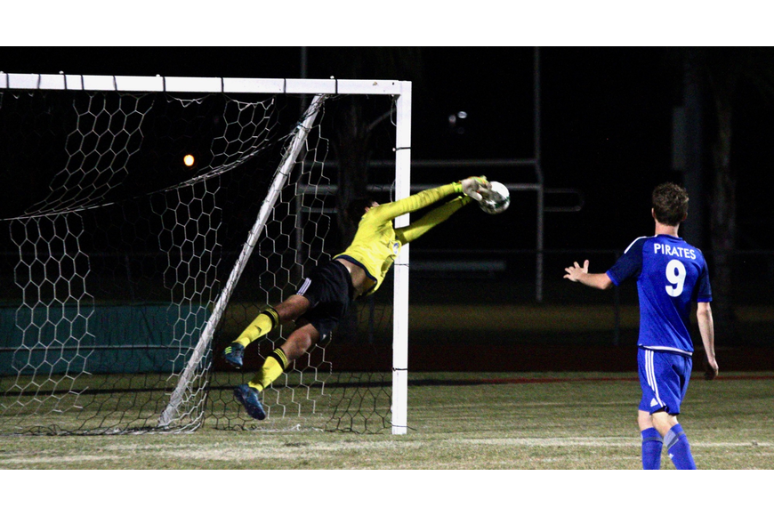 Matanzas goal keeper Brandt Herron leaps for a save in the first half. Photo by Ray Boone