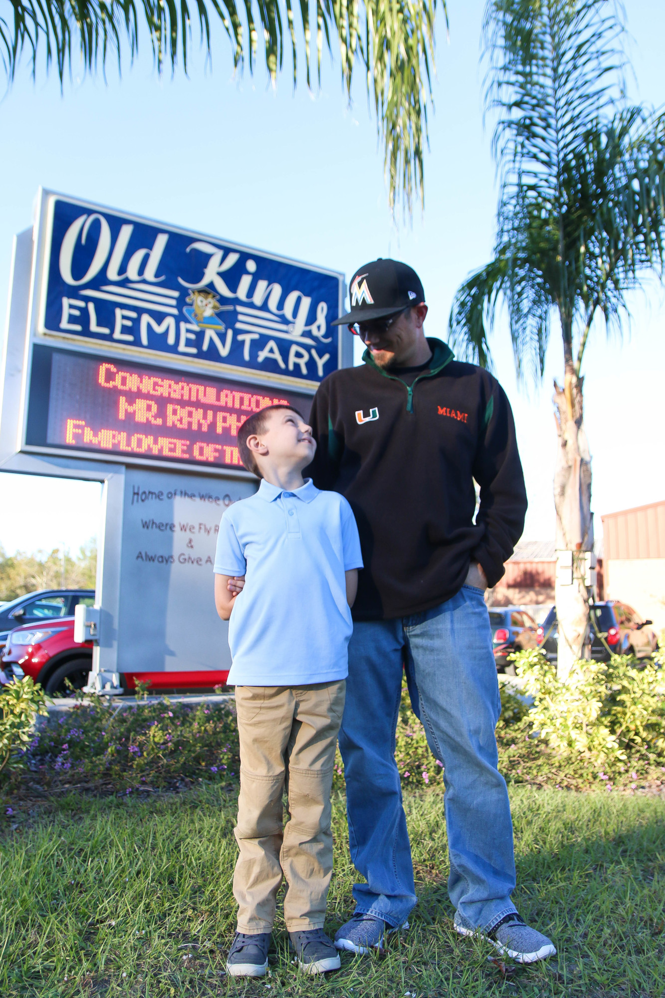 Chris Bruce and his son, Keegan Bruce, stand in front of Old Kings Elementary, where Chris recently started an All Pro Dads chapter to help local fathers engage with their kids' school lives. Photo by Paige Wilson