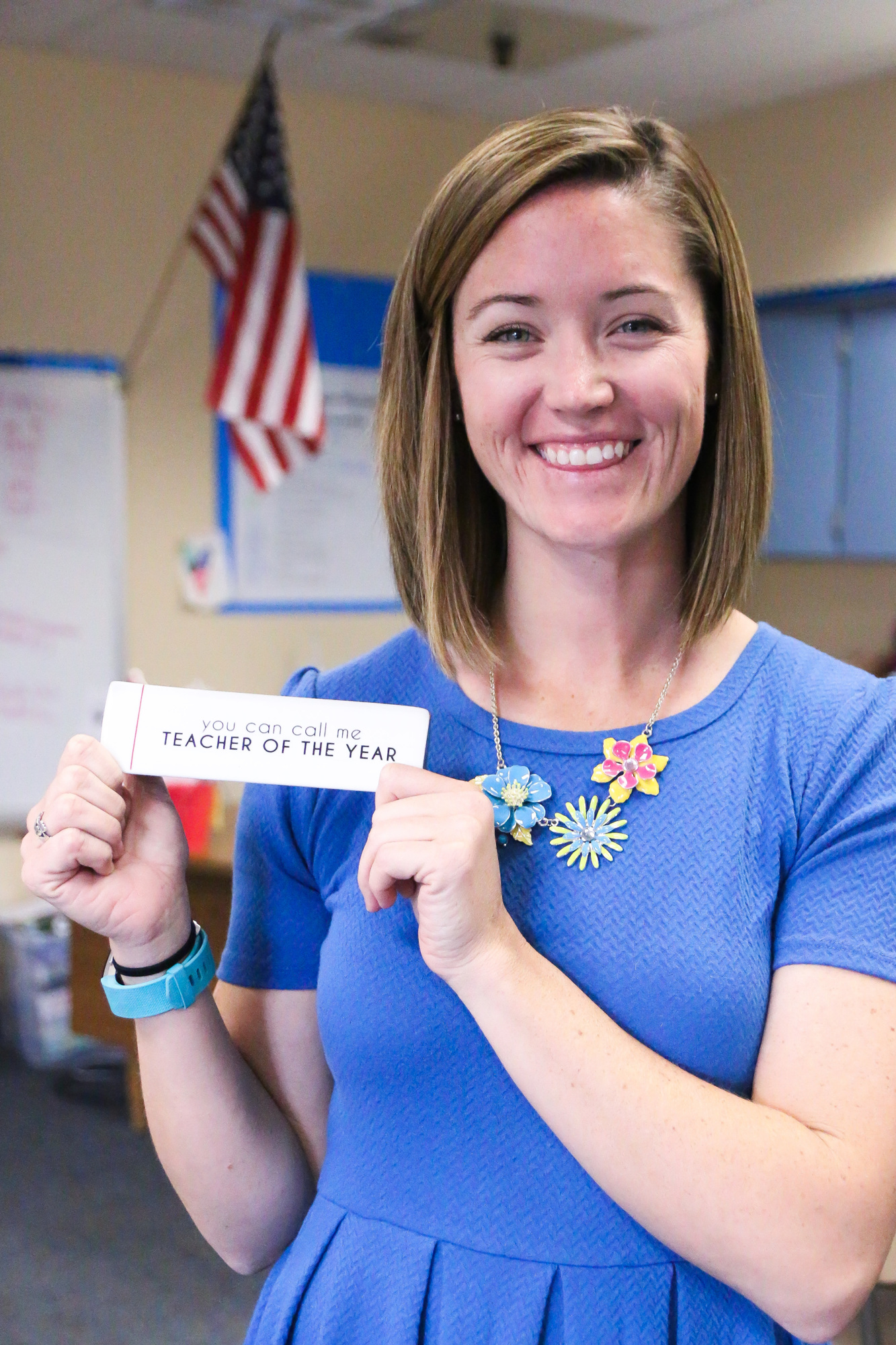 Ashley Reynolds holds up a Teacher of the Year token for her desk. Photo by Paige Wilson