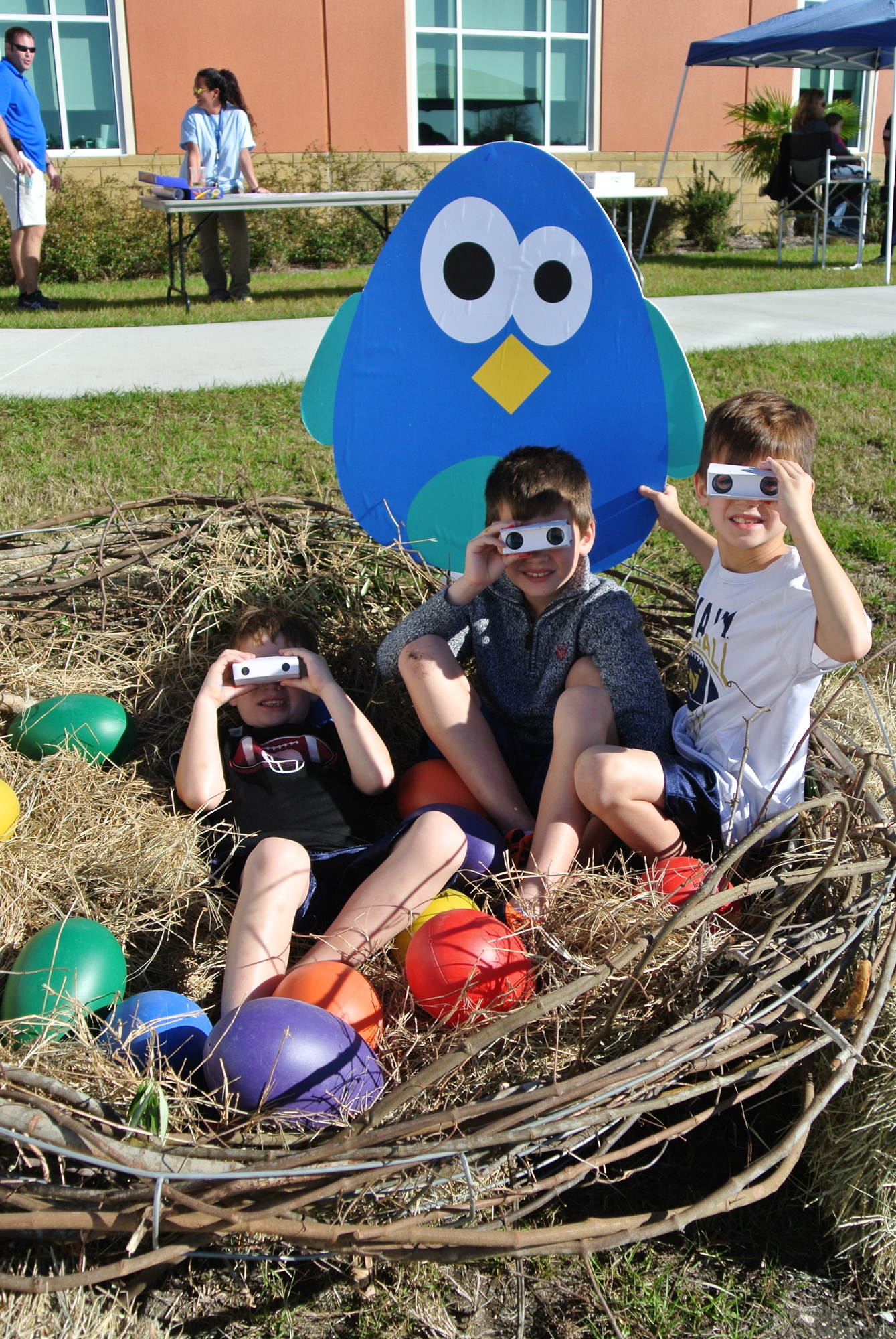 Children aim their binoculars while playing in the eagle’s nest at the 2017 Birds of a Feather Fest at Palm Coast City Hall. Photo courtesy of Cindi Lane