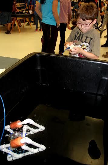 Wyatt Whittemore controls a SeaPerch underwater robotic at the Flagship Showcase on Saturday. Photo by Jacque Estes