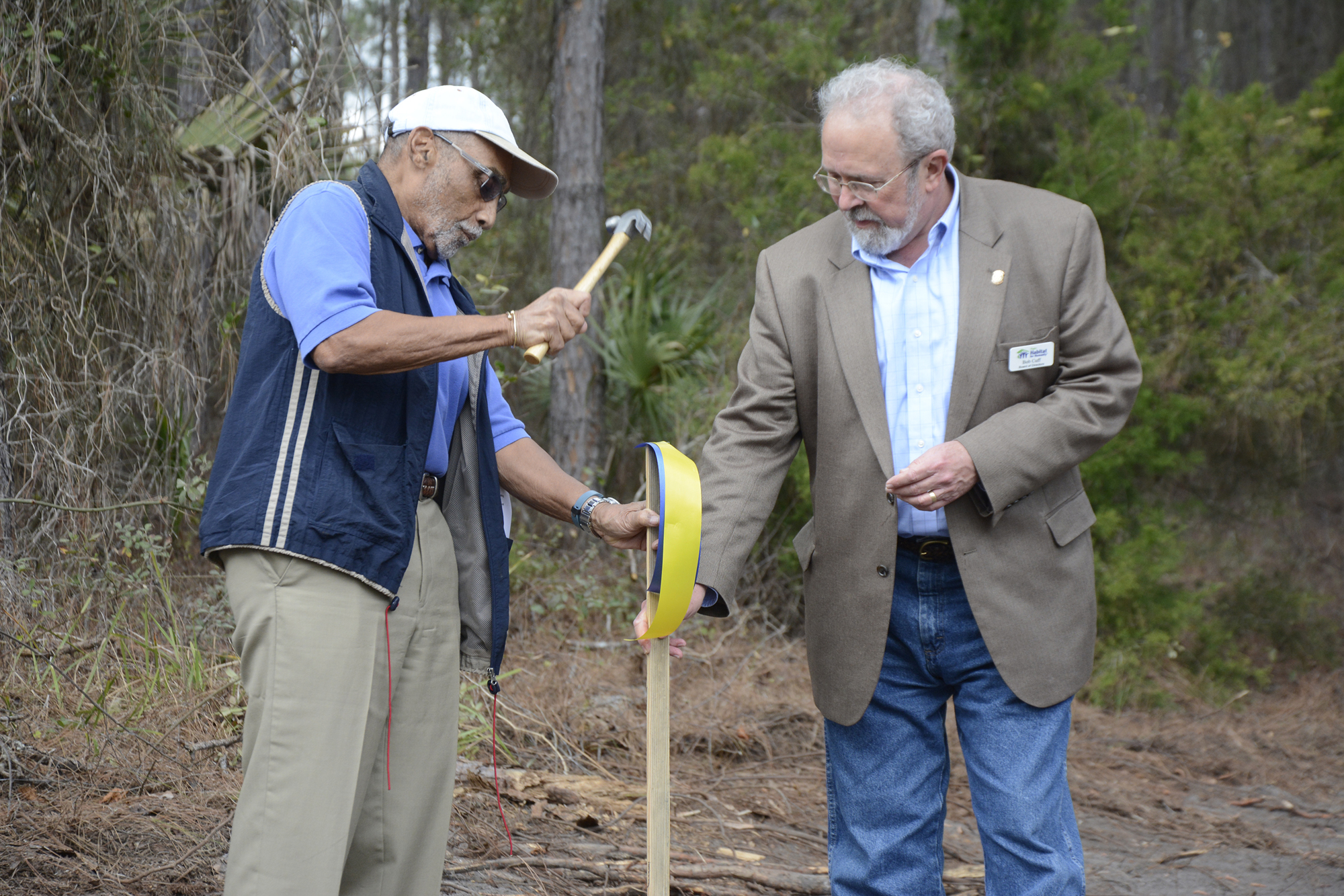 The first stake was drilled into the ground by past Flagler Rotary Club President Jim Callender with founding and current member of the Flagler Habitat Board of Directors Bob Cuff, in honor of Dr. Jim Guines.