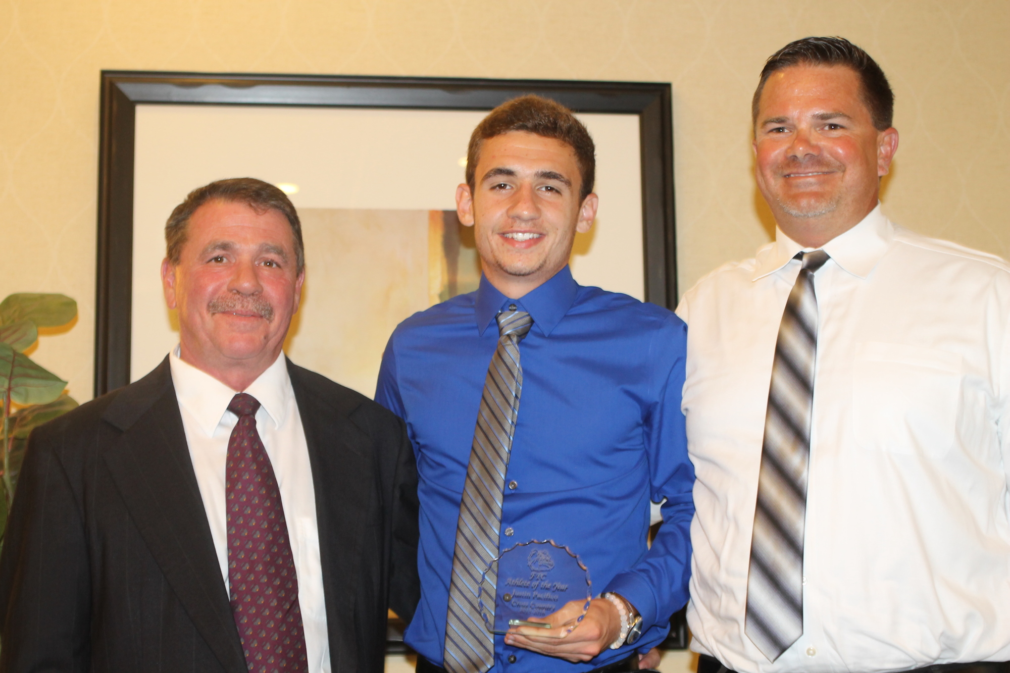 Justin Pacifico, pictured with Athletics Director Stephen DeAugustino and coach David Halliday