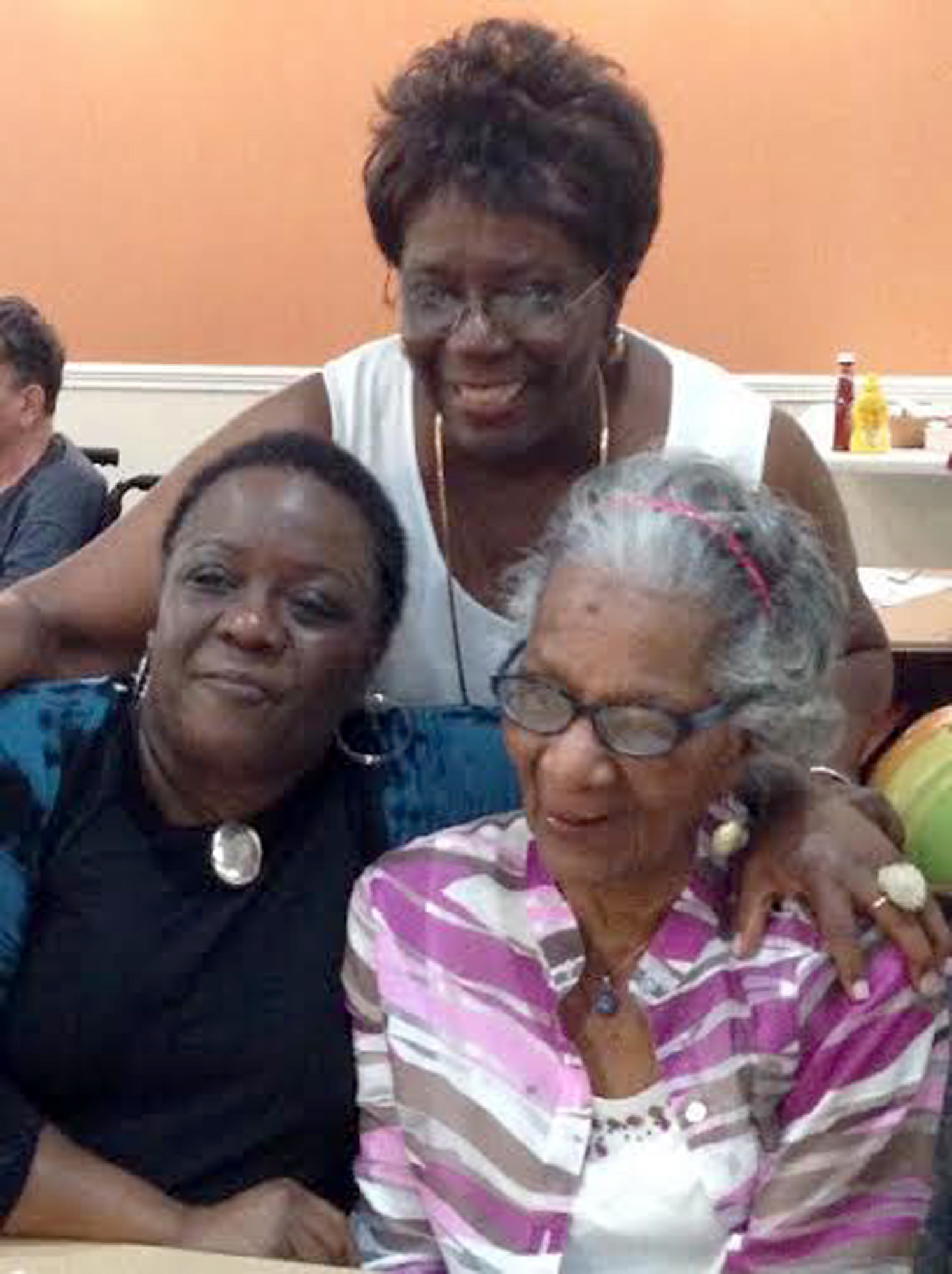 Sandra Nurse stands behind her daughter, Robin Lynne Nurse, and her mom, Mamie T. Watkins, who recently celebrated her 100th birthday, Courtesy photo