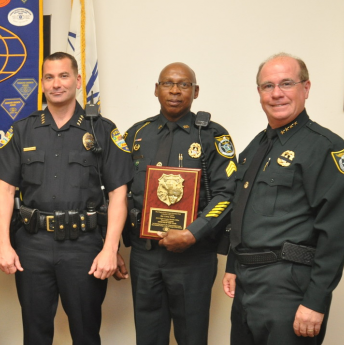 Larry Jones, pictured here with Jeff Hoffman and Sheriff Jim Manfre, was recognized by the Kiwanis Club as a deputy of the year in May 2013 for his efforts with Christmas with a Deputy.