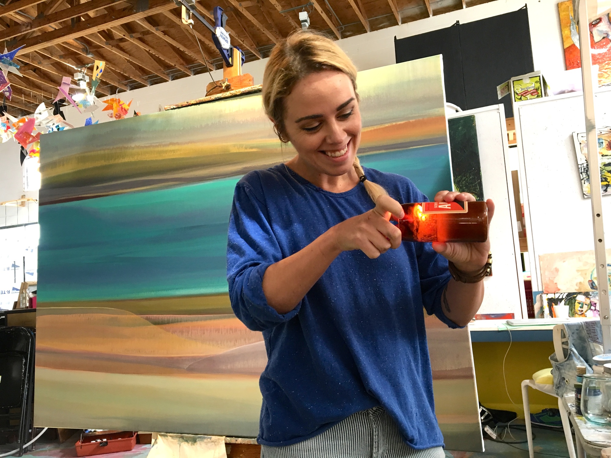 Petra Iston lights a candle as she works on a new painting, exploring a new style.
