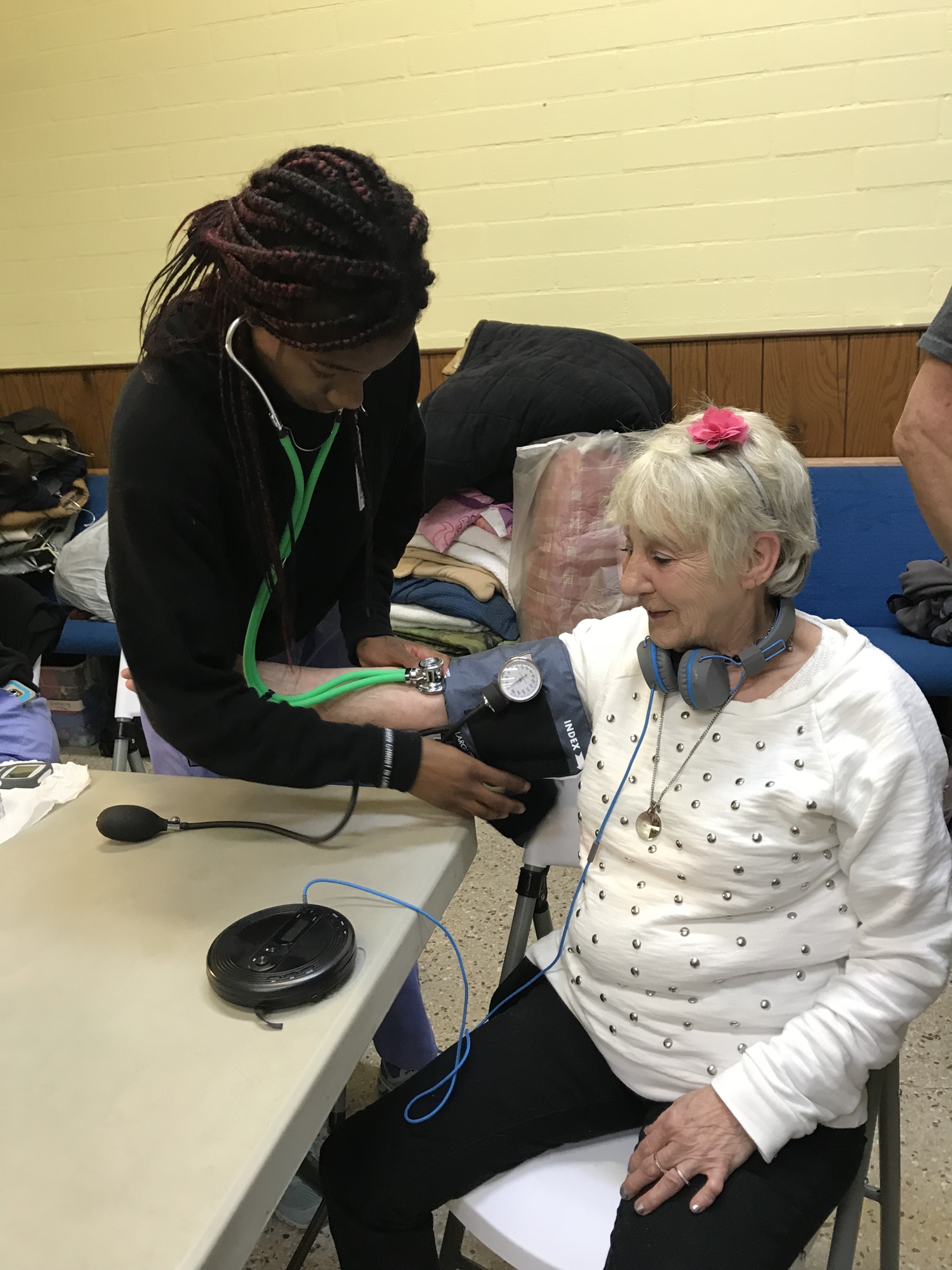 Flagler Technical Institute student Namiah Simpson takes the vitals of a client at The Sheltering Tree. Photo courtesy of Kathryn Weed