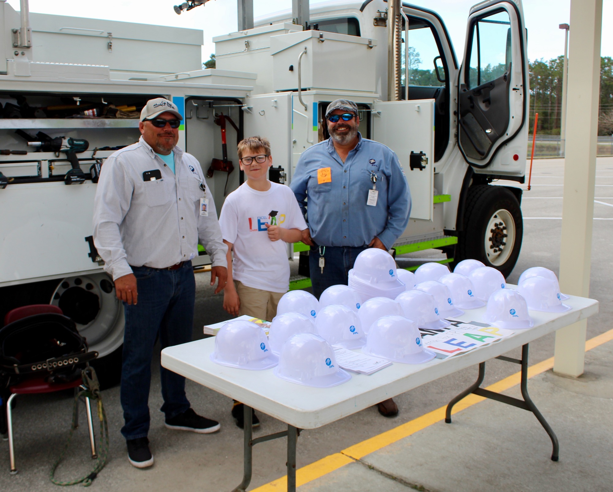 Rymfire Elementary student Caden Cavas meets with the FPL workers at the RES Career Day. Photo courtesy of Melanie Tahan
