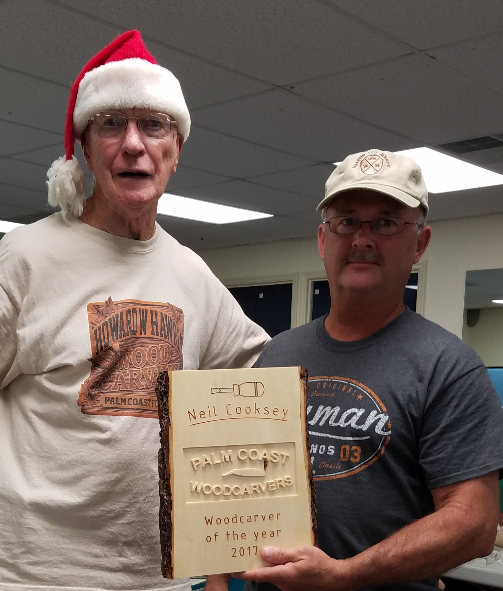 President Howard W. Hawrey presents the 2017 Carver of the Year award, carved by Jeff Kindon, to Neil Cooksey. Courtesy photo