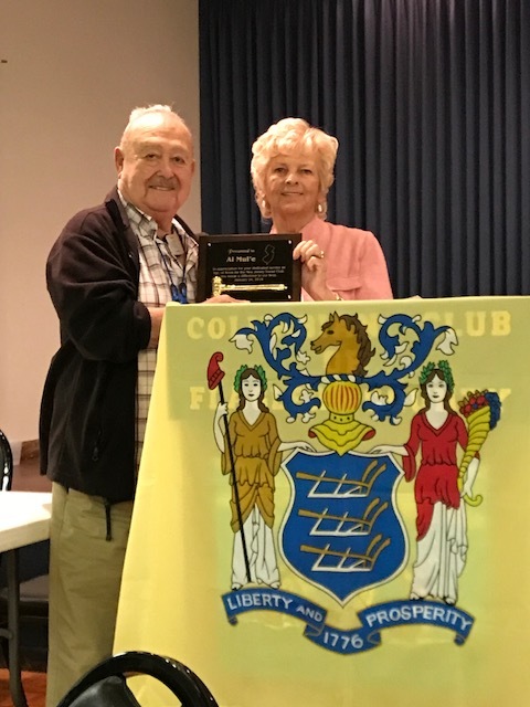 Al Mule earns an award for his many years of service from New Jersey Social Club President Carol Sloat. Photo courtesy of Penni Knapp