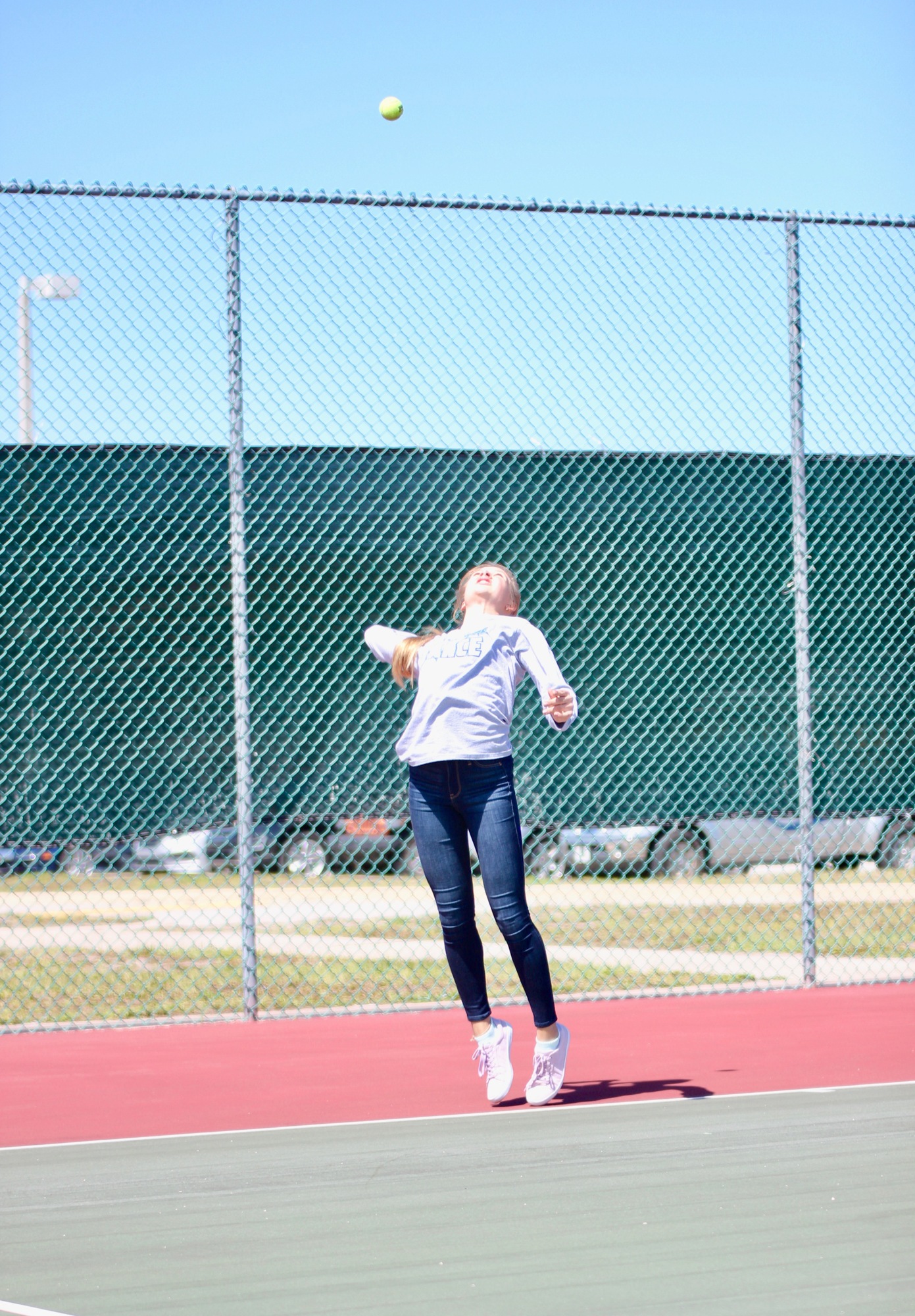 The Pirates' Natalie Valenteychik hits a serve. Photo by Ray Boone