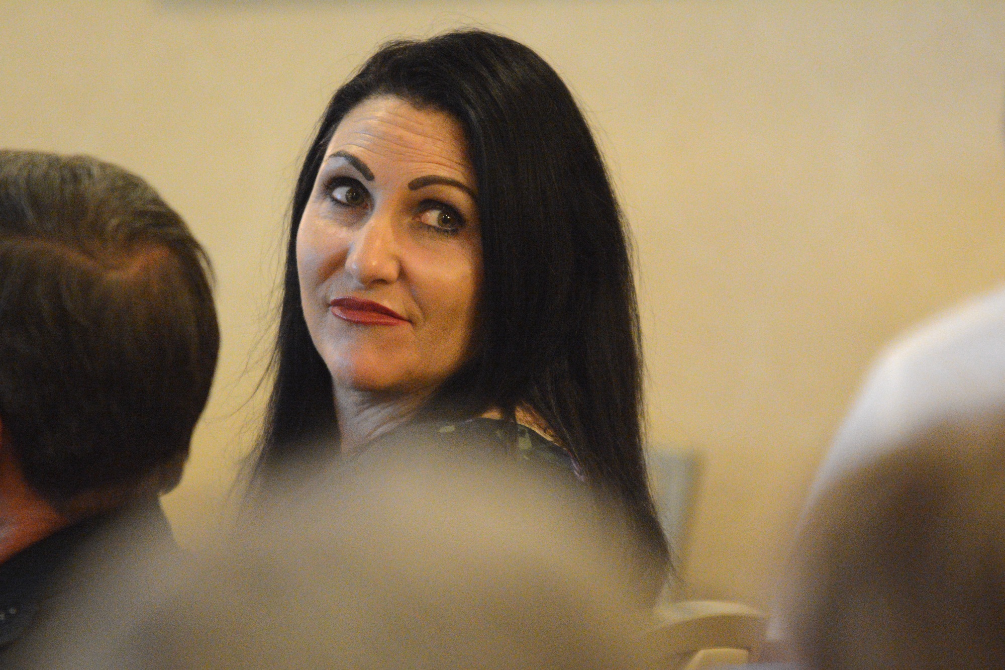 Palm Coast Mayor Milissa Holland turns to listen to an audience member's question at the Addressing Crime Together meeting April 19. (Photo by Jonathan Simmons)