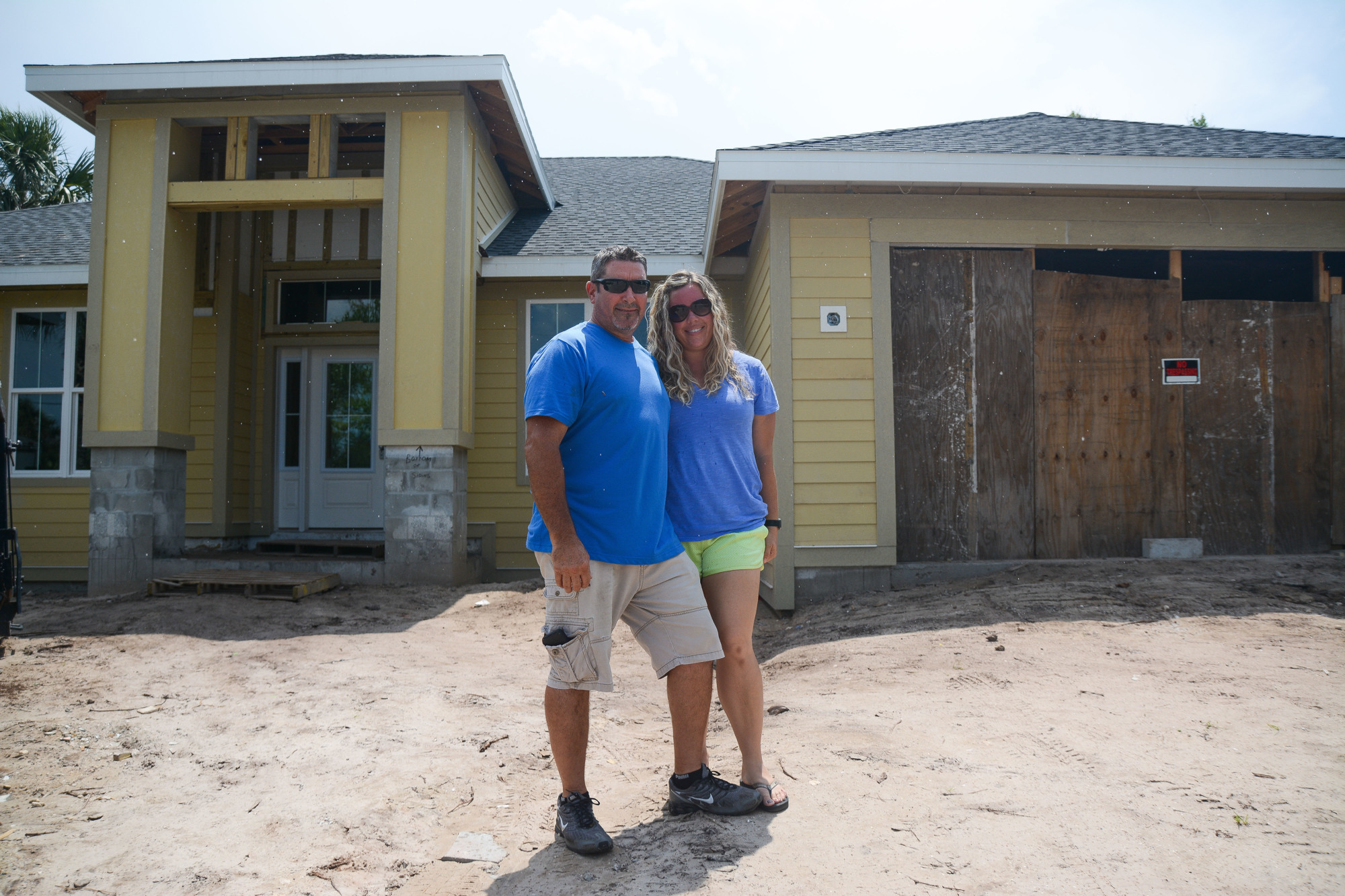 Joel and Beth Boyles stand outside their Flagler Beach home at the same property where they tore down their house after Hurricane Matthew ripped off the roof. Photo by Paige Wilson