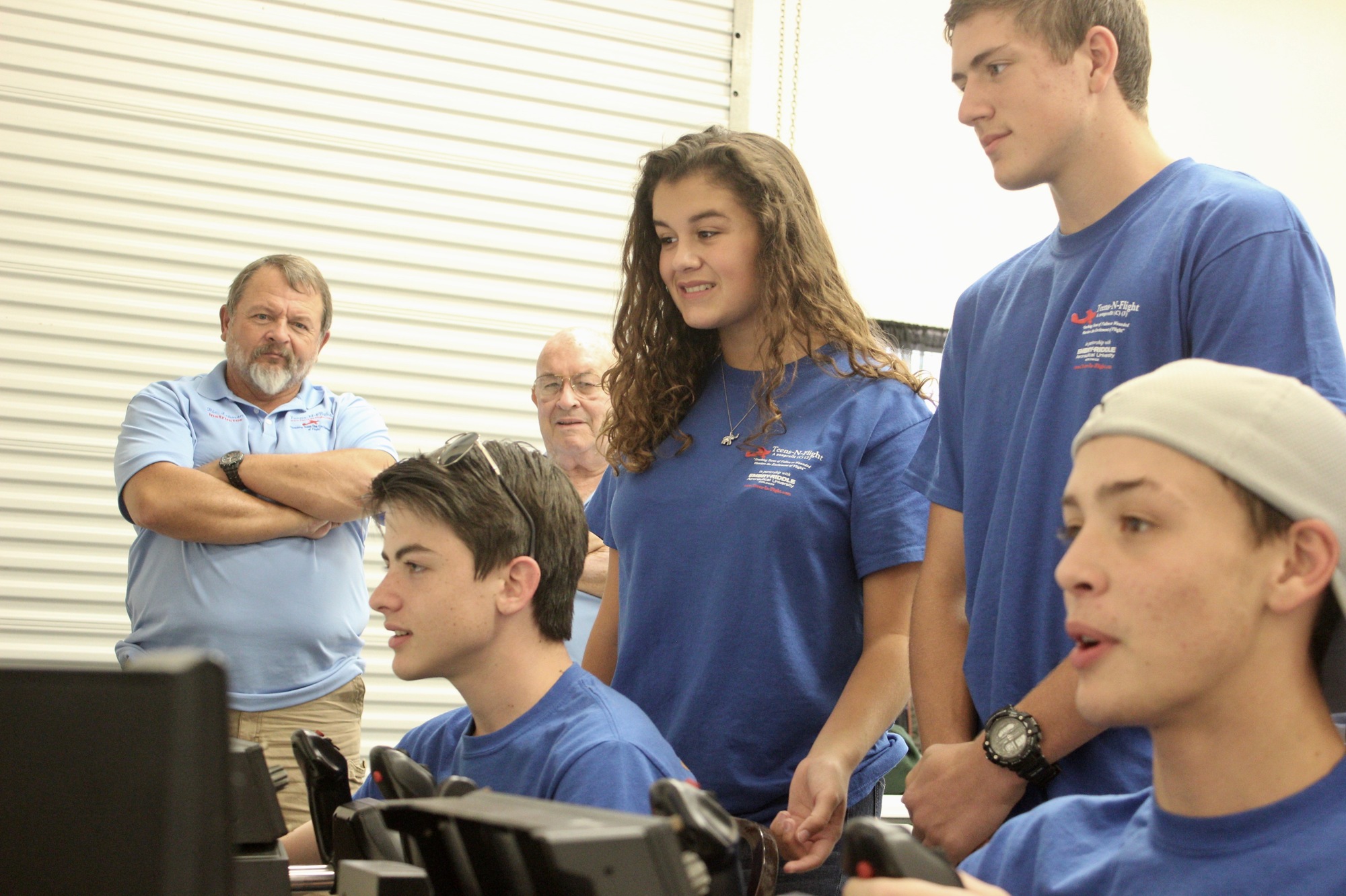 The students practice their aviation skills on a flight simulator. Photo by Ray Boone