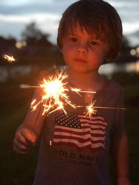 Palm Coast resident Kellan Ball enjoys his first sparkler during the July 3 celebration of Independence Day at Central Park in Town Center. Photo courtesy of Kerry Ball