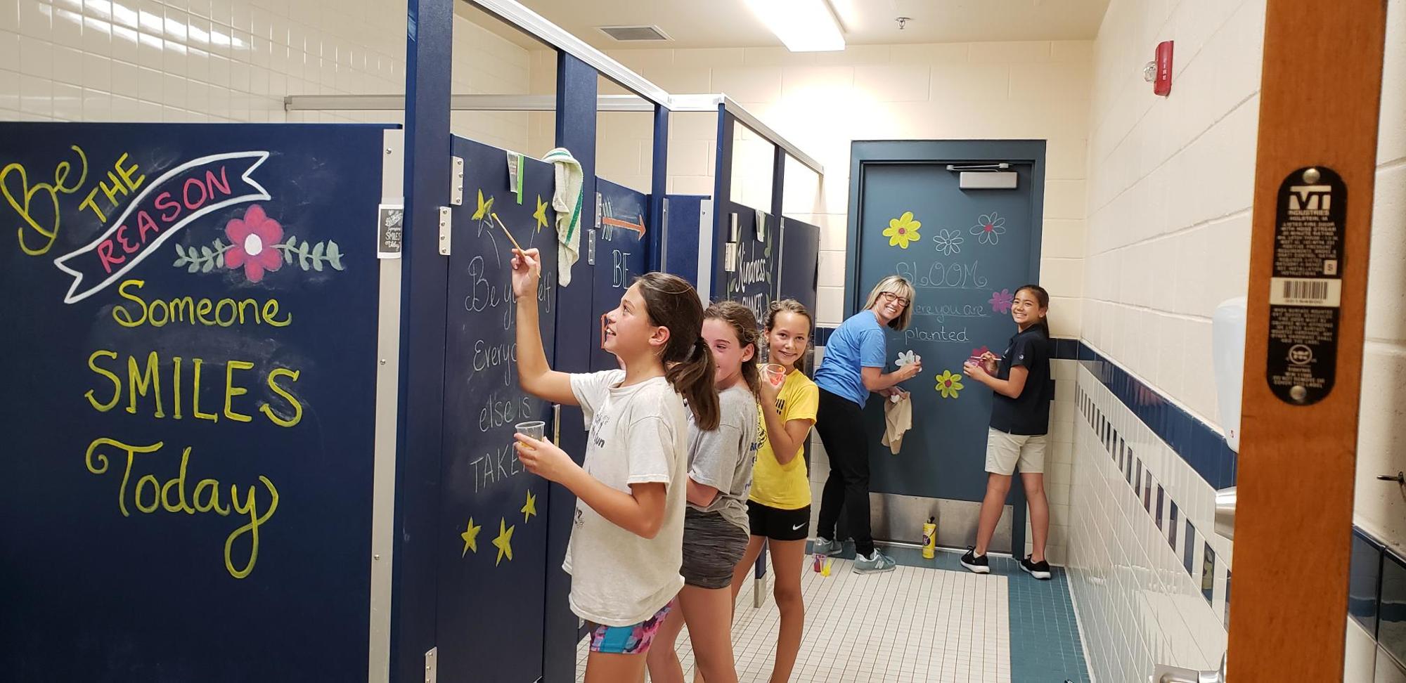 ISTC students Annabelle Moore, Mila McKee, Jordan Draugelat and Sydney Allen paint positive messages with parent Sandy Sylvester. Photo courtesy of ISTC