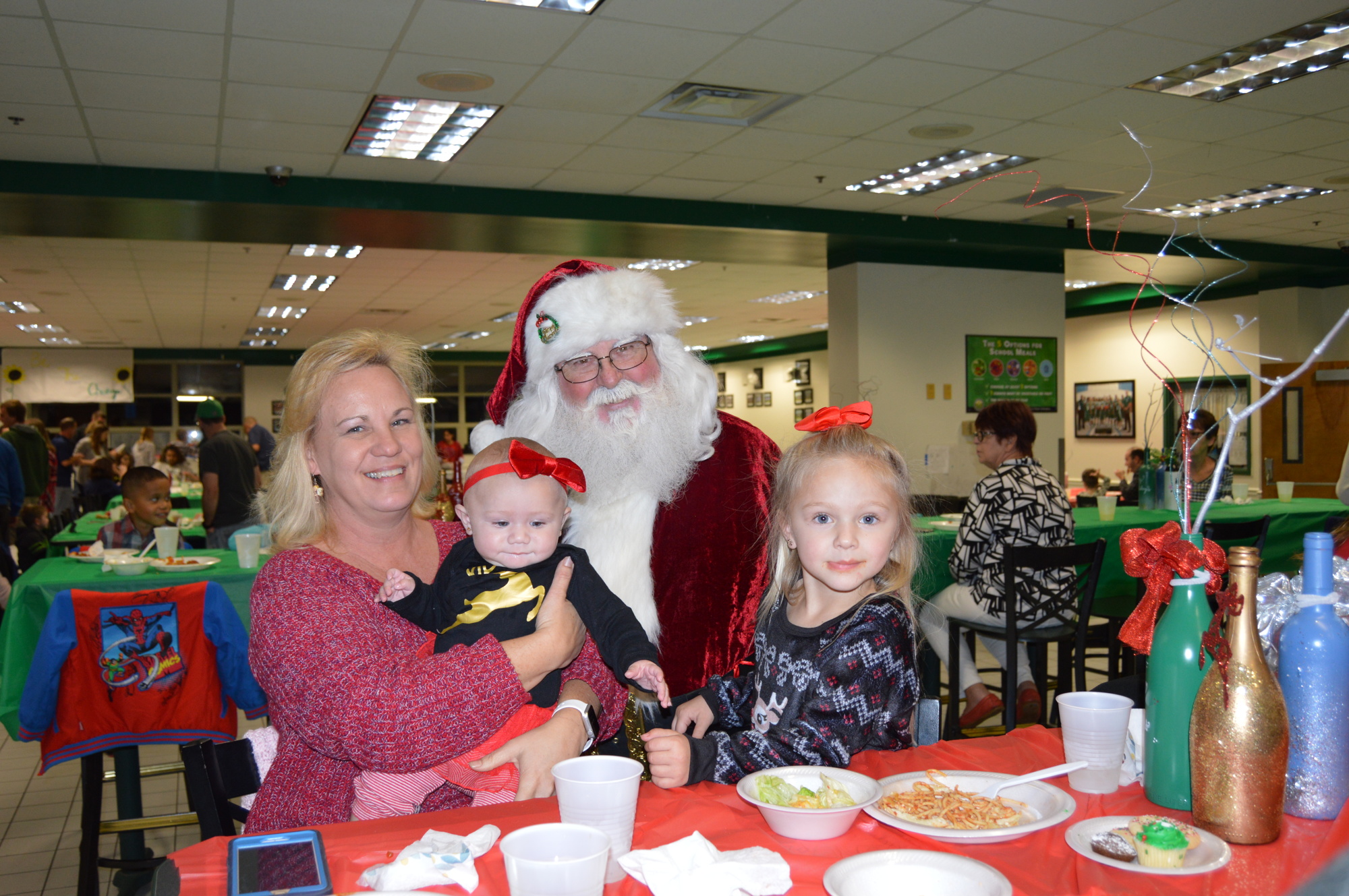 Santa Claus visits with Becky Cox with her granddaughters Clementine and Coralynn Soard at FPC's Dinner with Santa. Photo courtesy of FPCHS