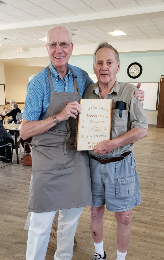 Past Program Director Howard Hawrey presents the Palm Coast Wood Carver of the Year for 2018 award to 92-year-old Jim Stephen. Courtesy photo