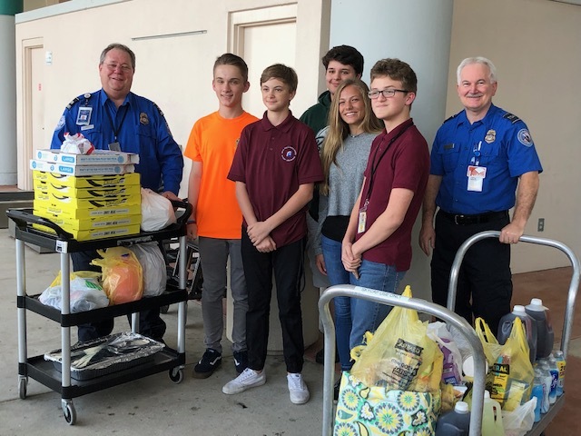 ITMS students Jackson Castañeda, Jack Petocz, Kevin Wolfe, Hannah Kurek and Cameron Driggers at the Daytona Beach International Airport with TSA workers. Courtesy photo