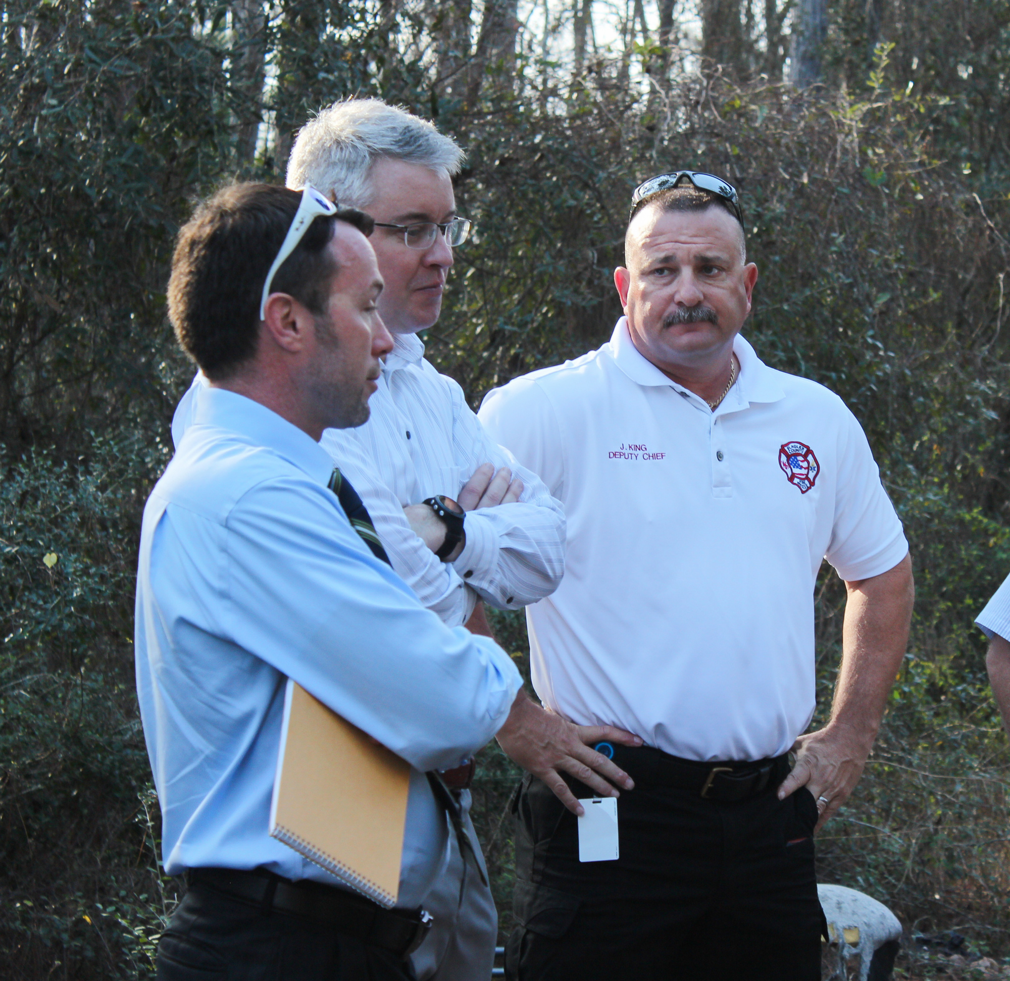 Assistant County Attorney Sean Moylan, Public Lands and Natural Resources Manager Tim Telfer and Flagler County Fire Rescue Deputy Chief Joe King discuss their observations on the homeless camp. Photo by Ray Boone