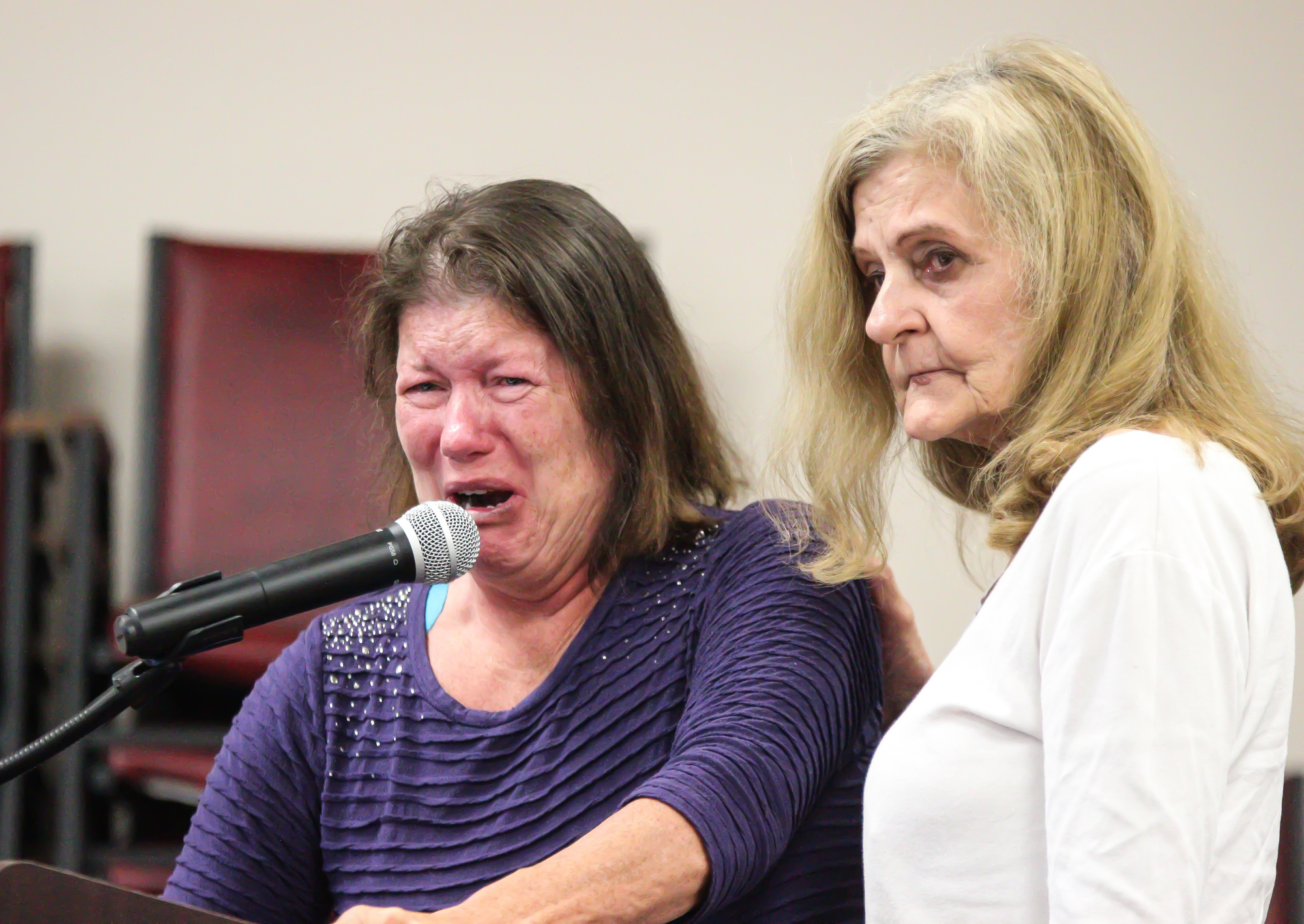 Bonnie Weygandt, who said she became homeless after her husband decided he didn't love her anymore, recalls her story to the council with fellow homeless woman Phyllis Adams consoling her. Photo by Ray Boone