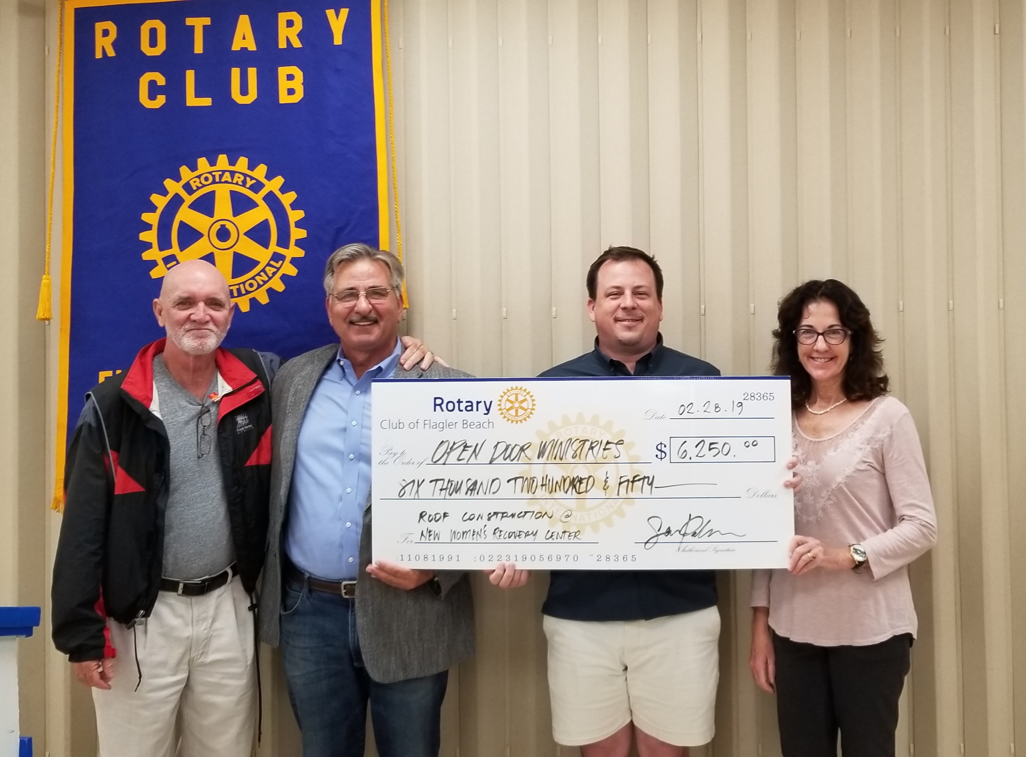 Art Macqueen, Pastor Charles Silano, Sean Palmer and Roseanne Stocker at the Rotary Club of Flagler Beach check presentation. Photo courtesy of Marketing2Go