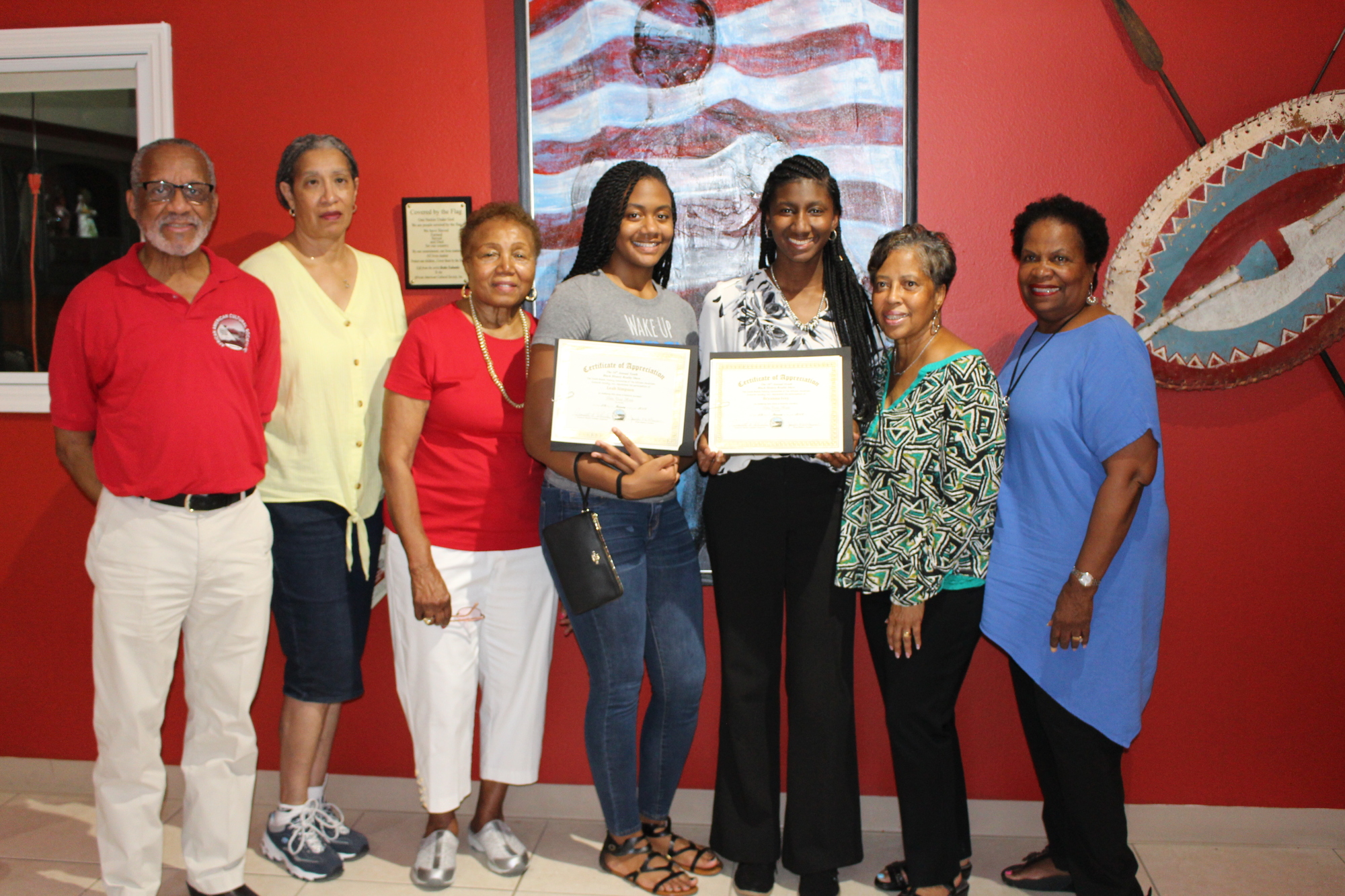 Students Leah Simpson and Bryanna Ivey receive AACS scholarship awards at the African American Cultural Center during the Juneteenth Celebration. Courtesy photo