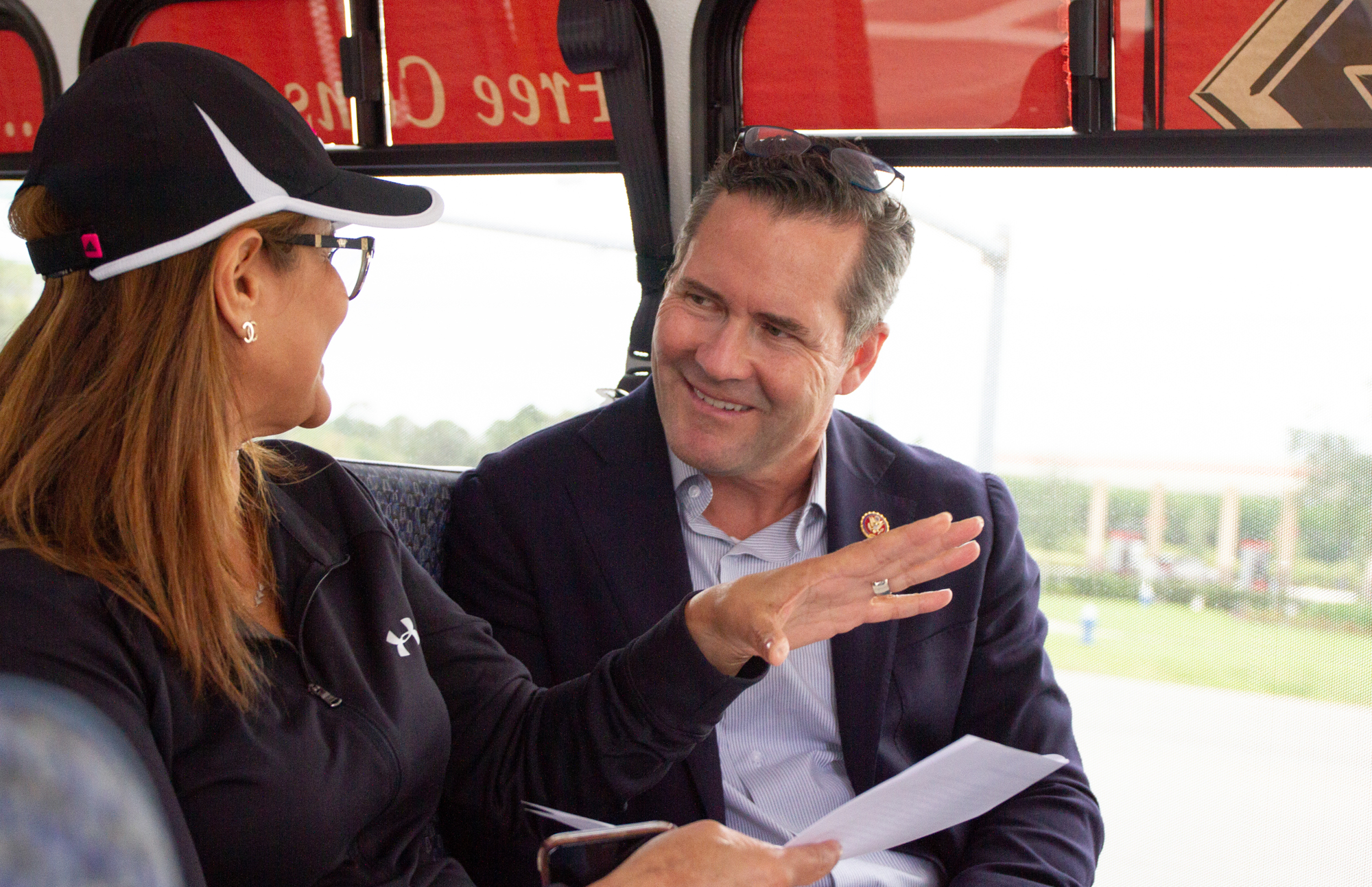 County Engineer Faith al-Khatib starts updating Congressman Waltz in the tour bus. Photo by Paola Rodriguez