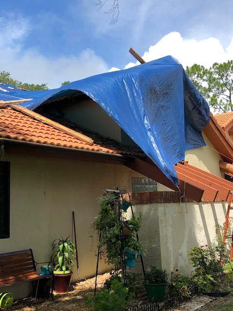 Workers placed a blue tarp over the damaged roof. (Courtesy photo)