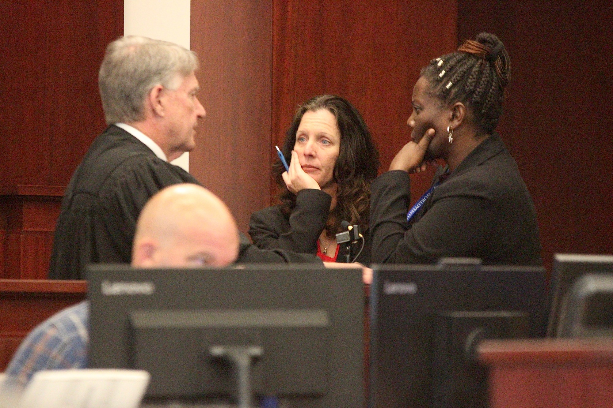 Circuit Judge Terence Perkins speaks with Assistant State Attorney Melissa Clark and defense attorney Regina Nunnally. Photo by Jonathan Simmons