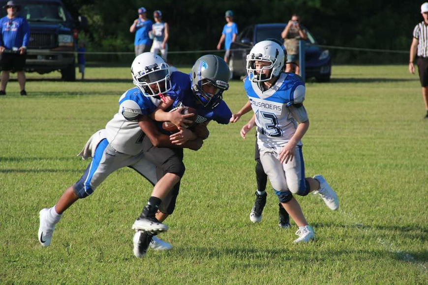 The Crusaders' defense brings down an opposing player during a regular season win. Courtesy photo