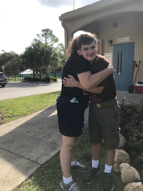 Eagle Scout candidate Philip Cangialosi and his mom, Helene, share a hug to celebrate the successful planting of 156 flowers and plants at the entrance to the Palm Coast Historical Society. Photo courtesy of the city of Palm Coast