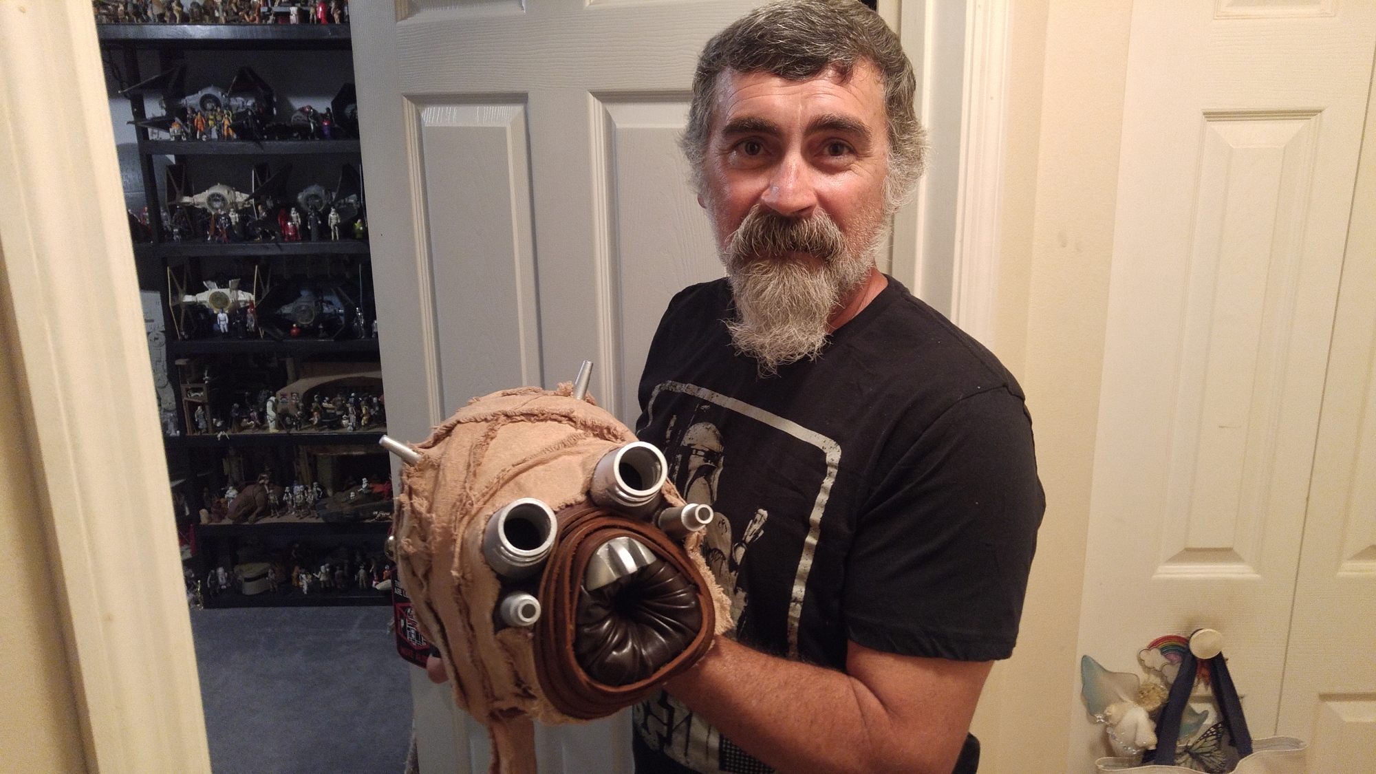 Keith DeDeo holds up the head of his Tuscan Raider costume. Photo by Brent Woronoff
