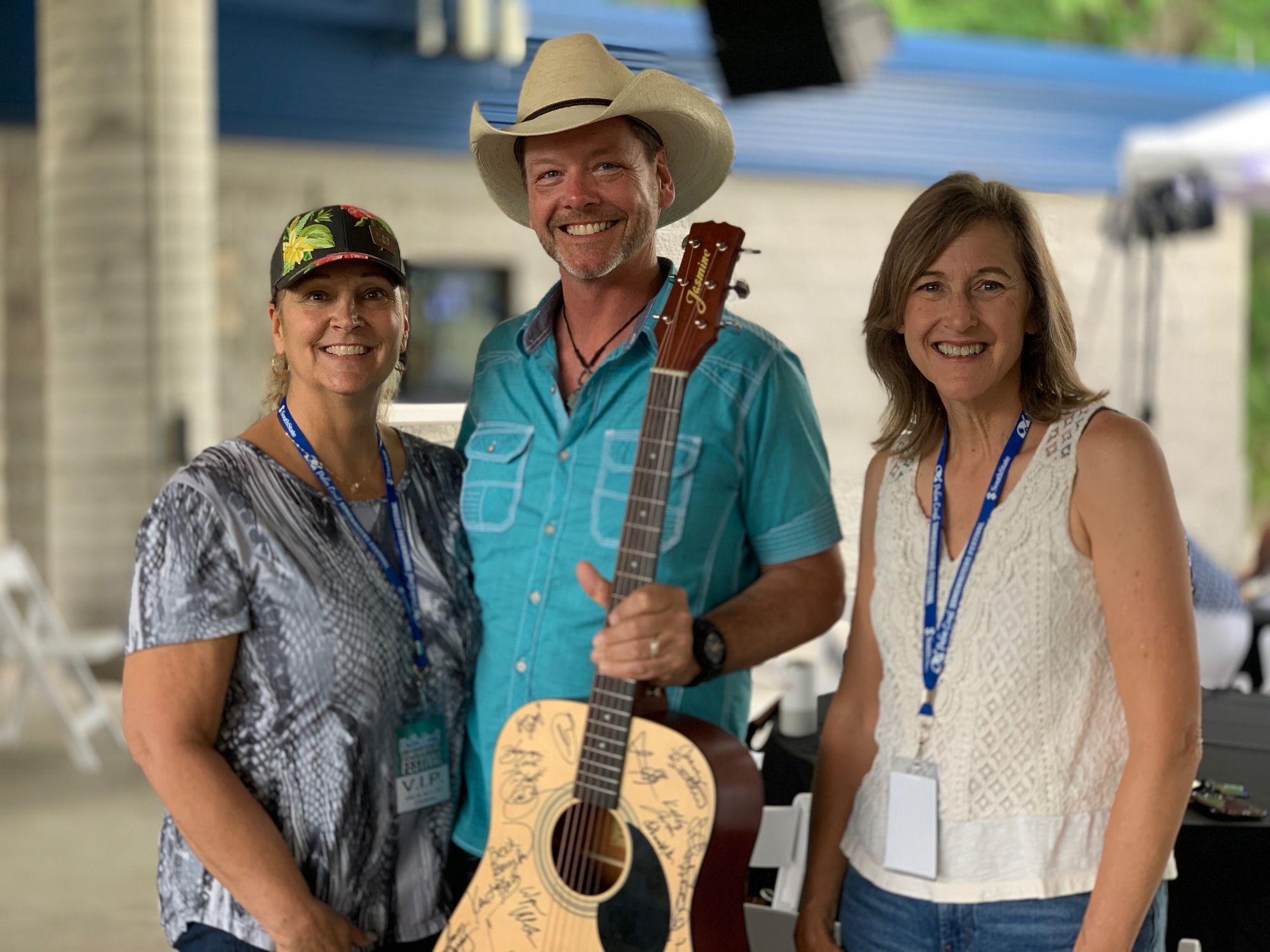 Elaine Bramlitt, of Bunnell, won the guitar raffled at the Palm Songwriters Festival. She is pictured here with songwriter Thom Shepherd and the Early Learning Coaliton's Nancy Walsh.  Courtesy photo