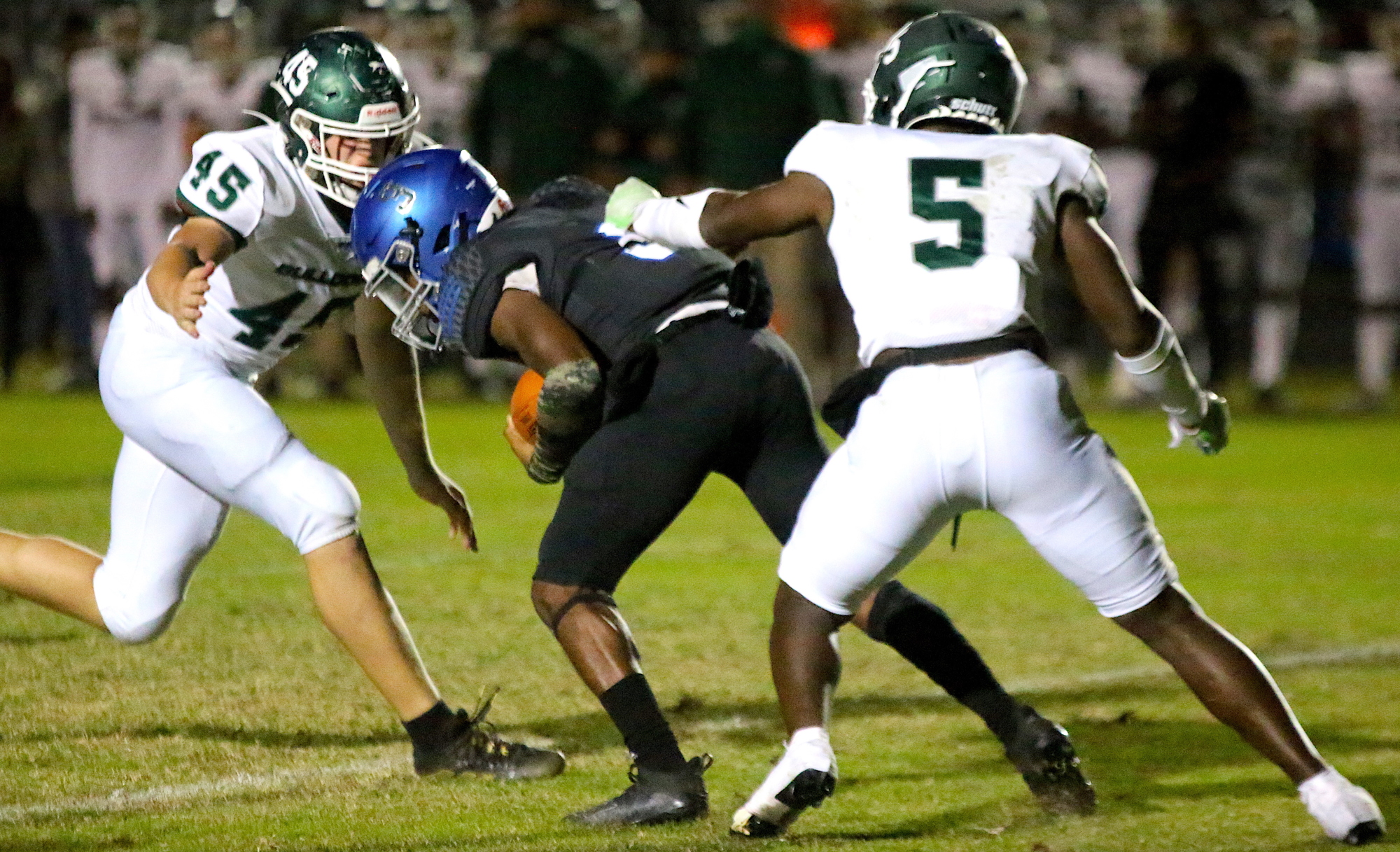 FPC defensive end Colby Cronk and linebacker R.J. Hill converge on Matanzas quarterback Dakwon Evans. Photo by Brent Woronoff