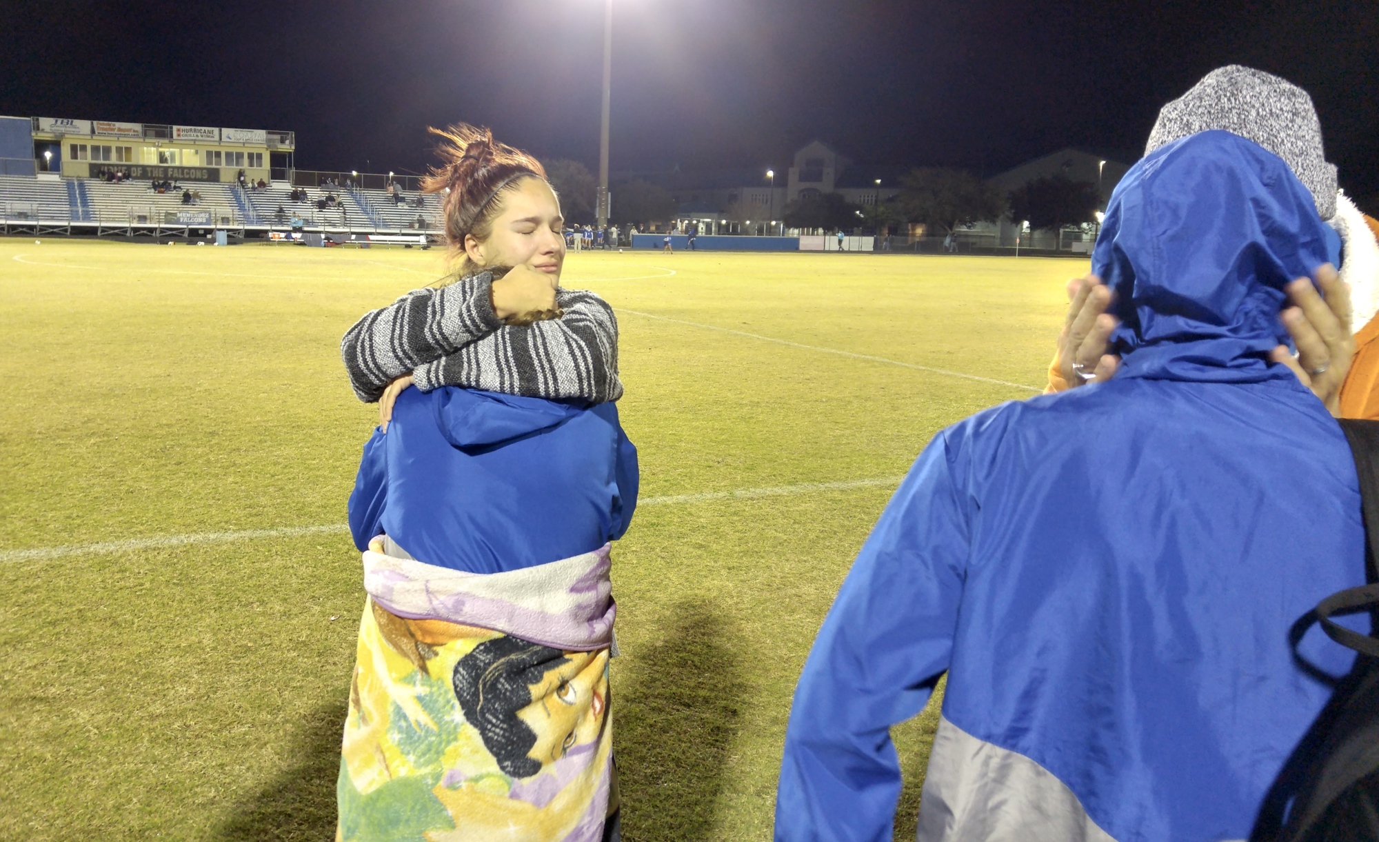 Fatima Barham hugs one of her teammates after the game. Photo by Brent Woronoff