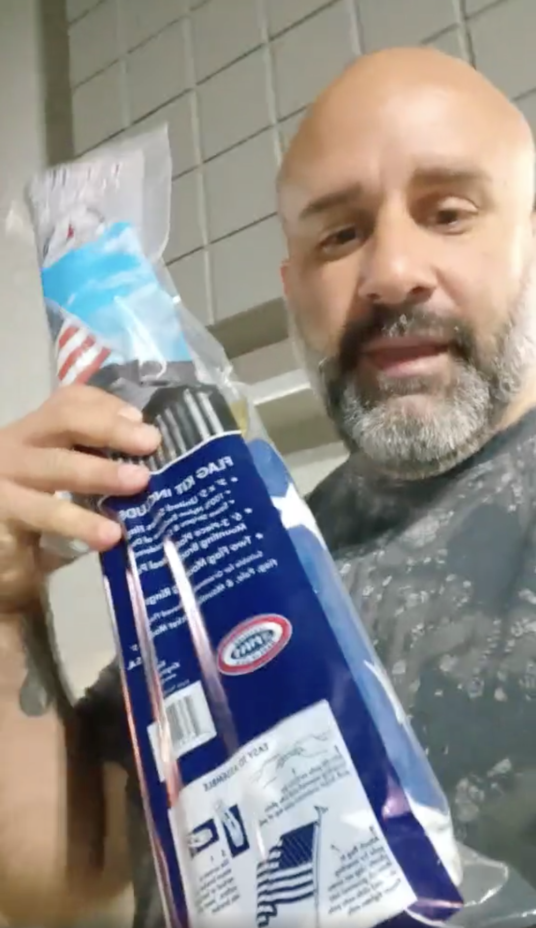 Victor Barbosa, in a Facebook Live video, holds up a U.S. flag he bought at Walmart after his trespass order was lifted.