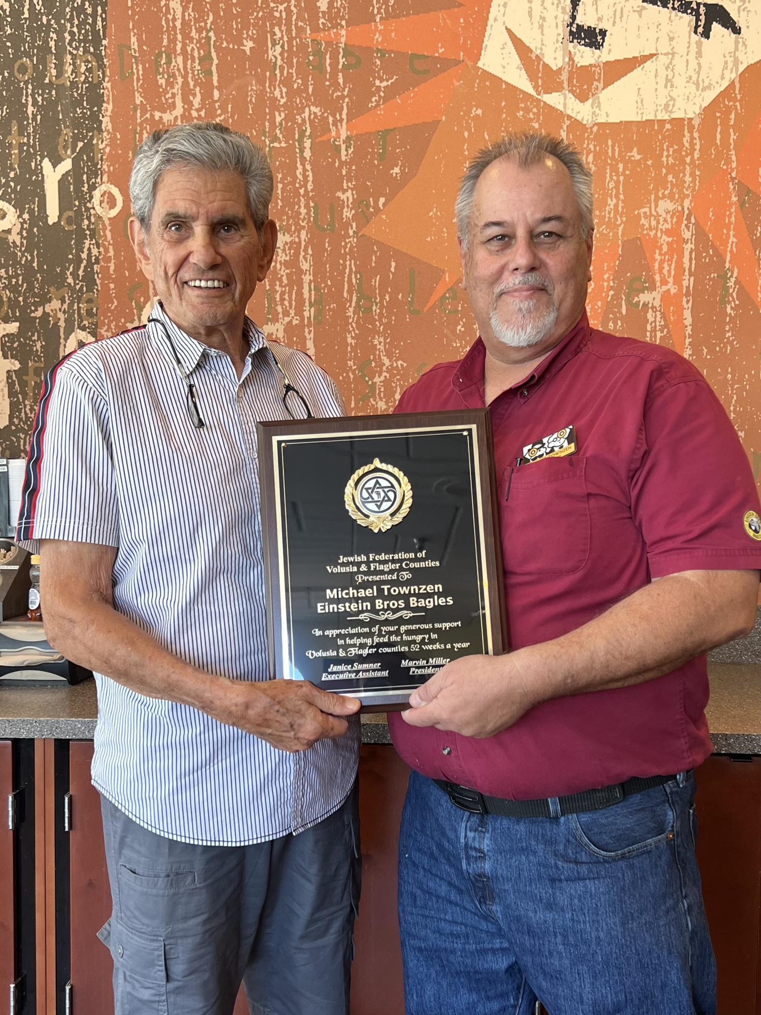 Marvin Miller, president of the Jewish Federation of Volusia and Flagler Counties, and Michael Townzen, general manager of the local Einstein Bros. Bagels. Courtesy photo