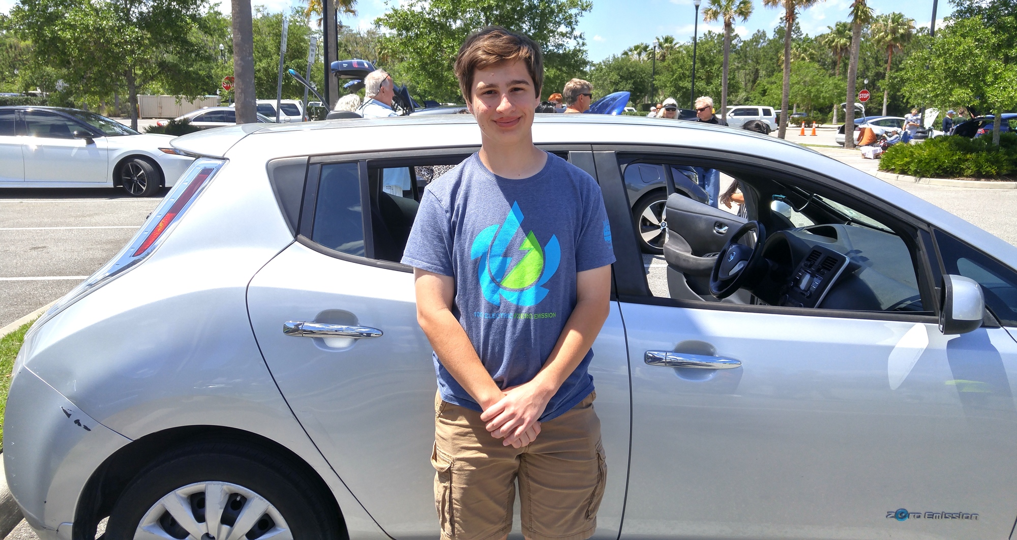 Dylan Long stands in front of the his 2013 Nissan Leaf.  Photo by Brent Woronoff