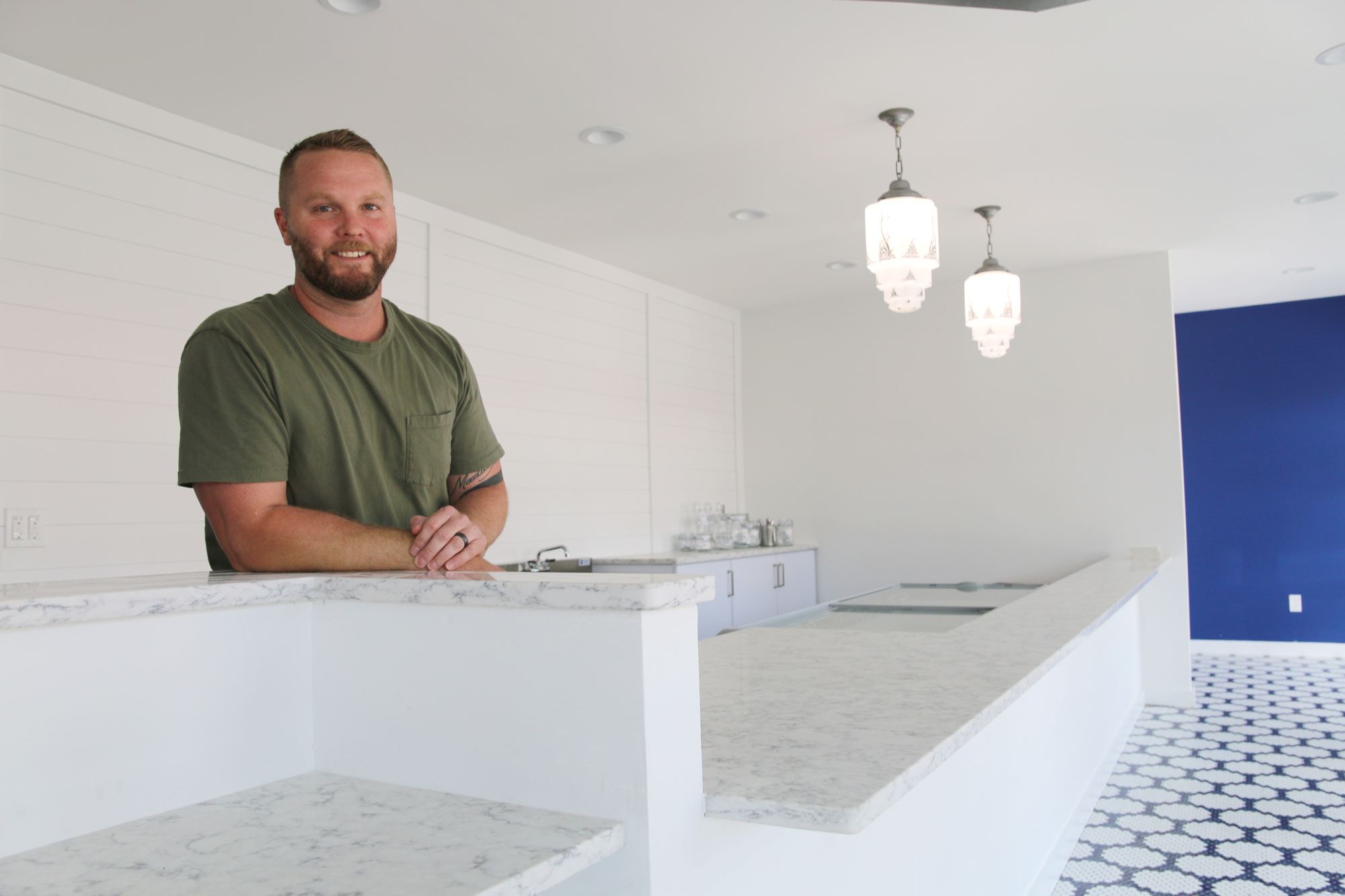 Craig Frick didn't want Neighborhood Scoop to resemble the average ice cream parlor; he wanted less pastels, and more trendy colors and fixtures. Photo by Jarleene Almenas