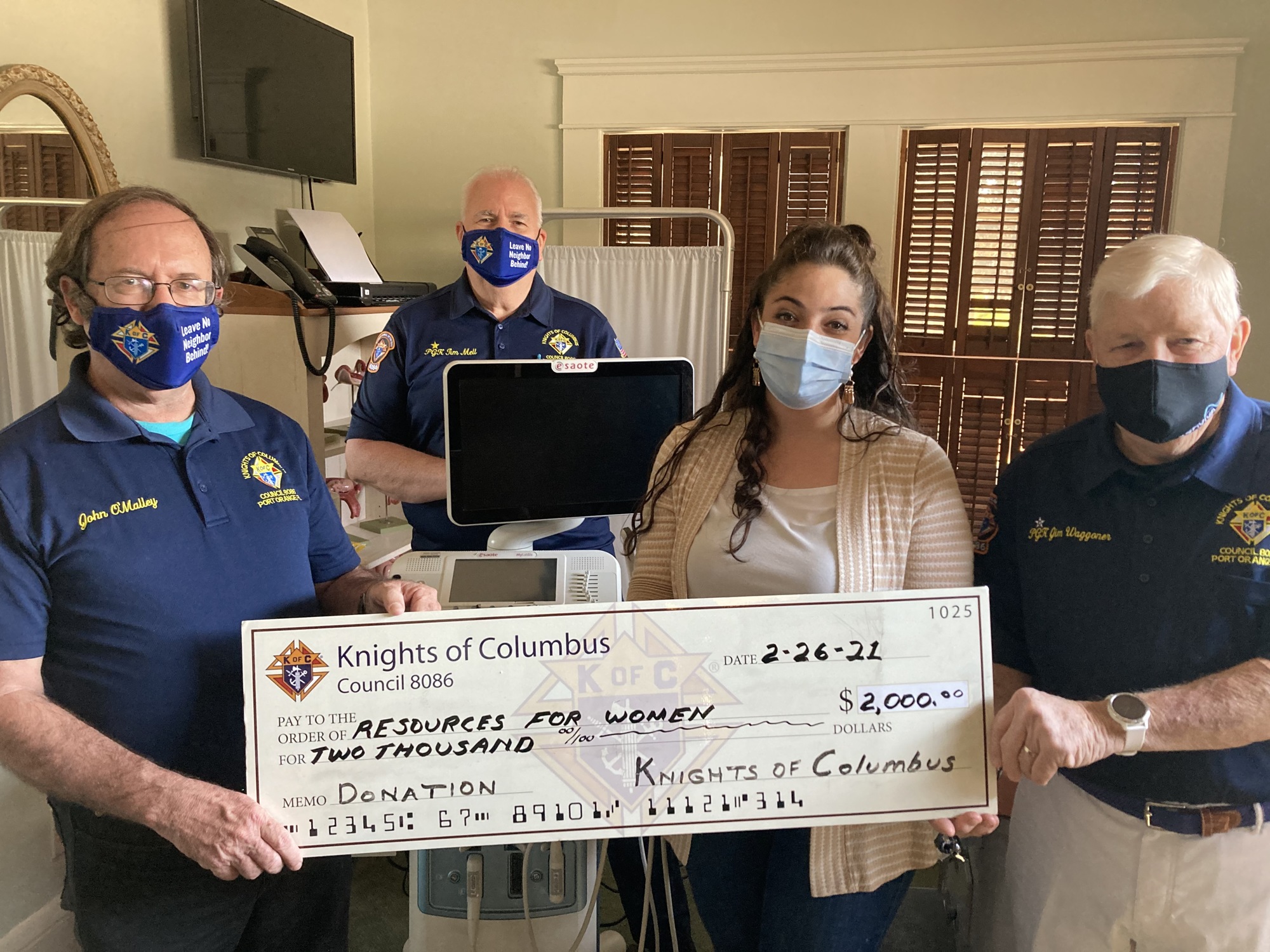 Council 8086 officers Grand Knight John O’Malley, Program Director Tim Mell and Jim Waggoner present a check for $2,000 to Resources for Women Executive Director Paola Sanchez. Courtesy photo